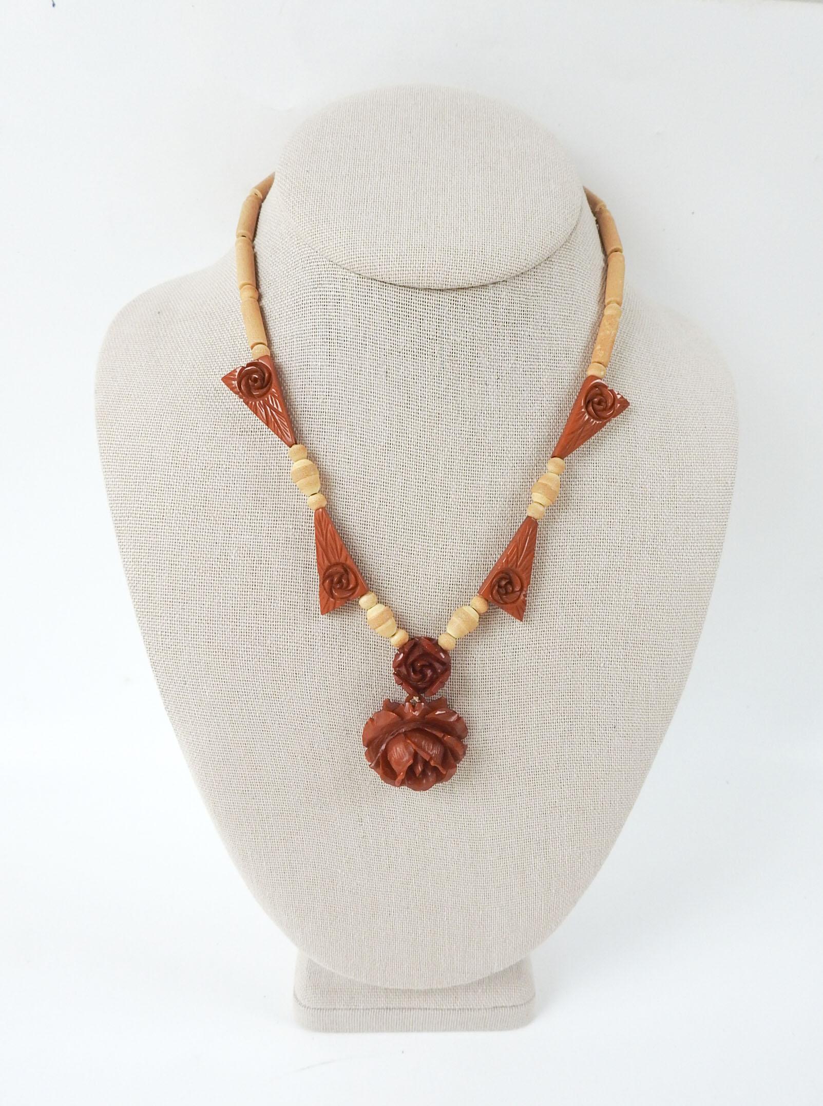 Circa 1930's carved butterscotch color bakelite rose pendant necklace.  Large rose is 1.25