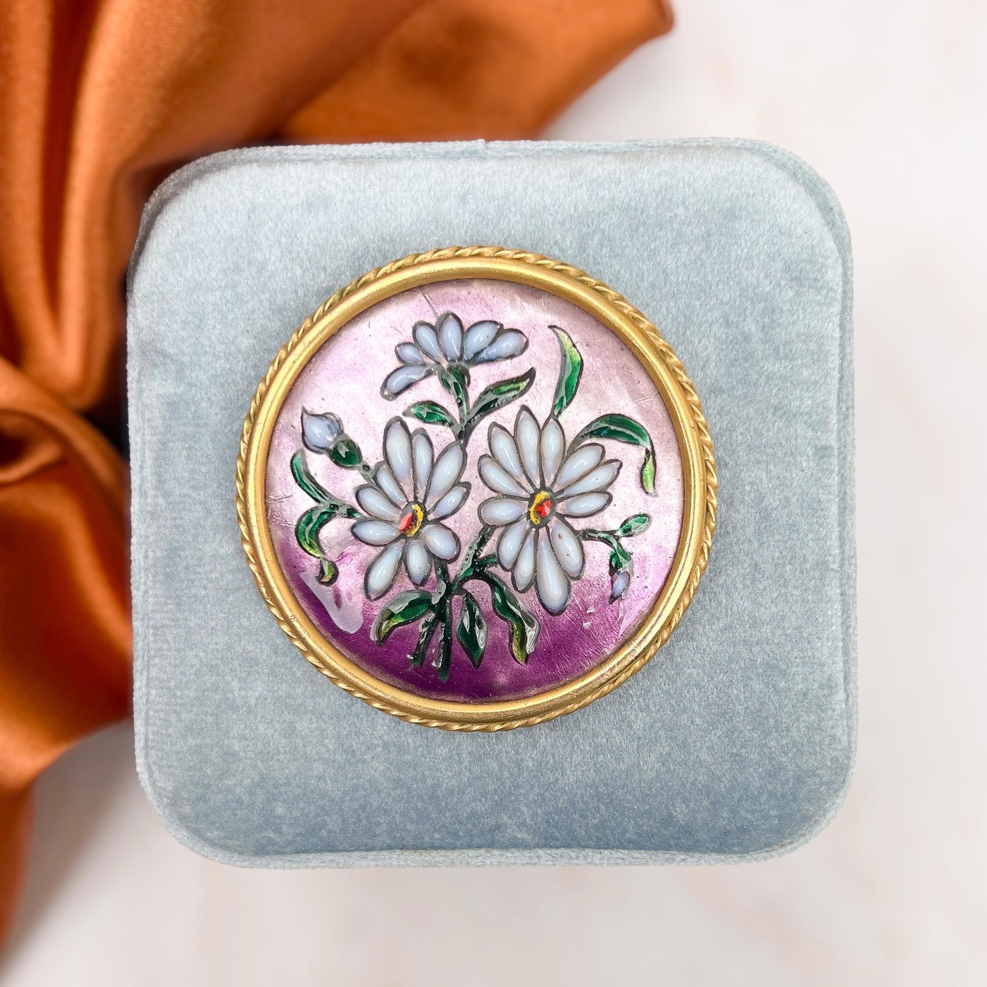 This pretty brooch was created in Paris in the 1930s.

Condition Report:
Excellent

The Details...
This brooch is constructed from a copper panel foiled and enamelled with a floral design. The panel is also detailed with poured glass in shades of