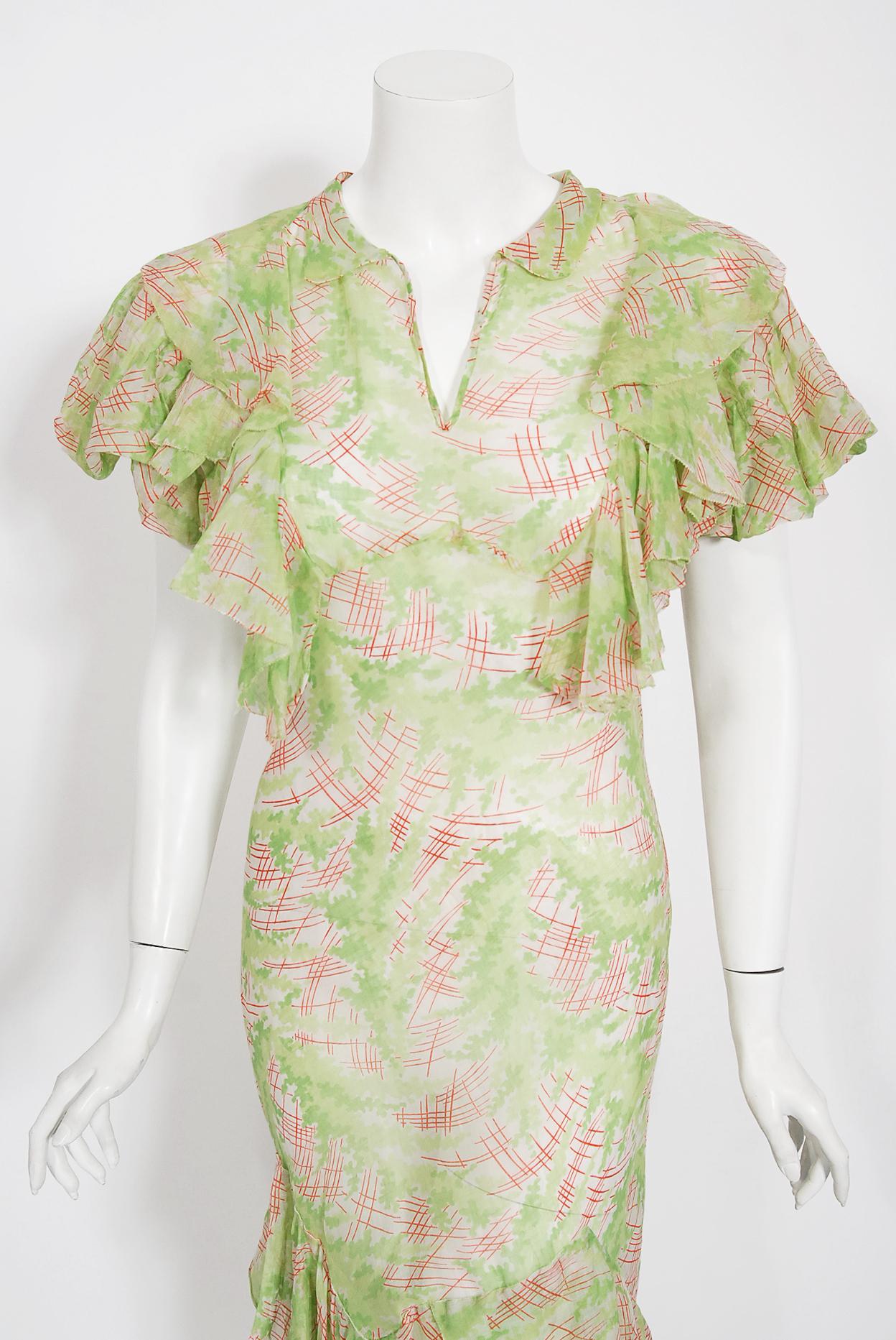Undiminished by time, this mid 1930's lime-green and pink sheer organdy gown still has such flirty charm. This exceptional beauty is fashioned in the highest quality organdy with the most stunning abstract deco watercolor print. I love the gorgeous