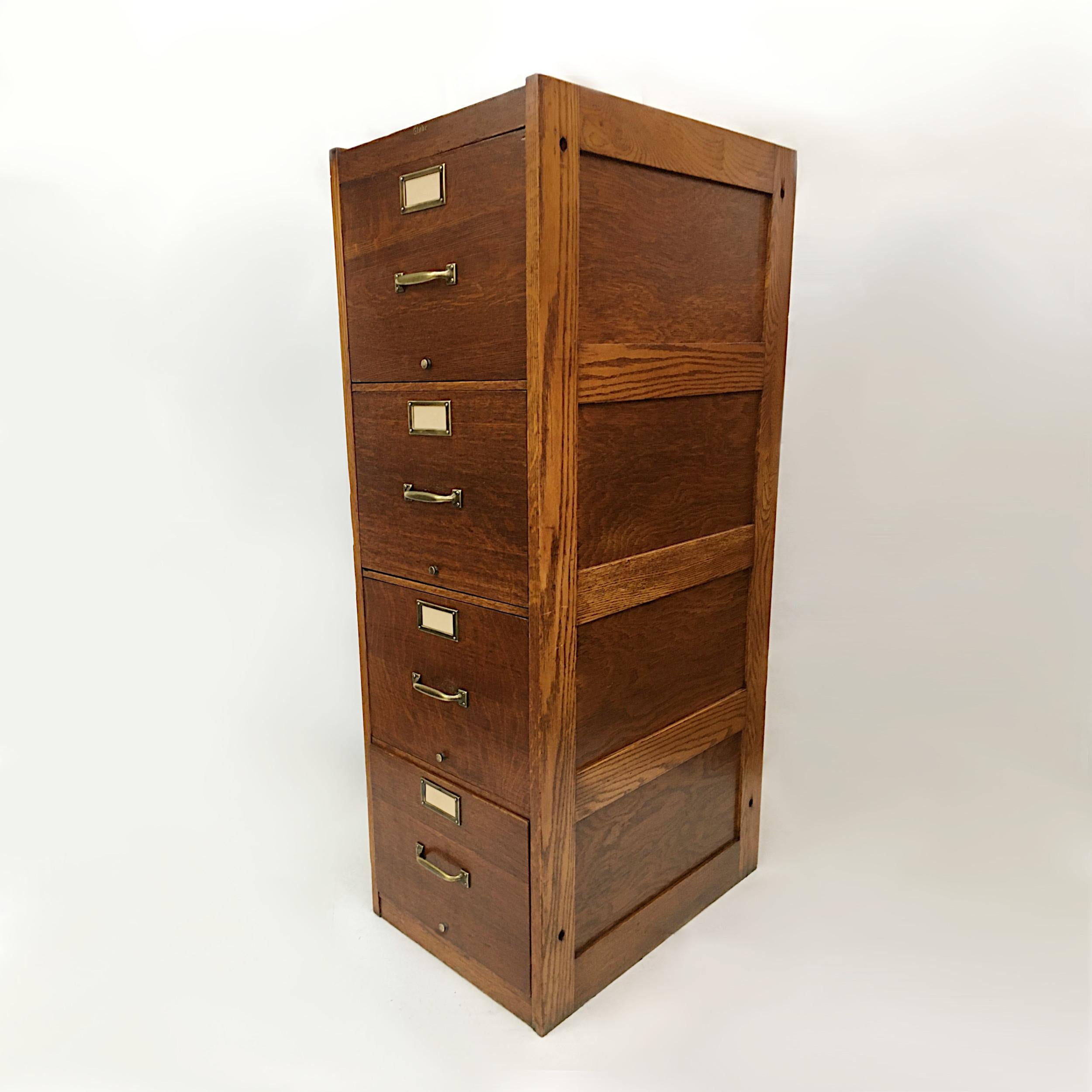 Very nice 1930s file cabinet by Globe Wernicke. Cabinet features solid oak construction with solid brass hardware and paneled sides. This cabinet has a wonderful mix of materials giving it a great Industrial look all in a compact size that can be
