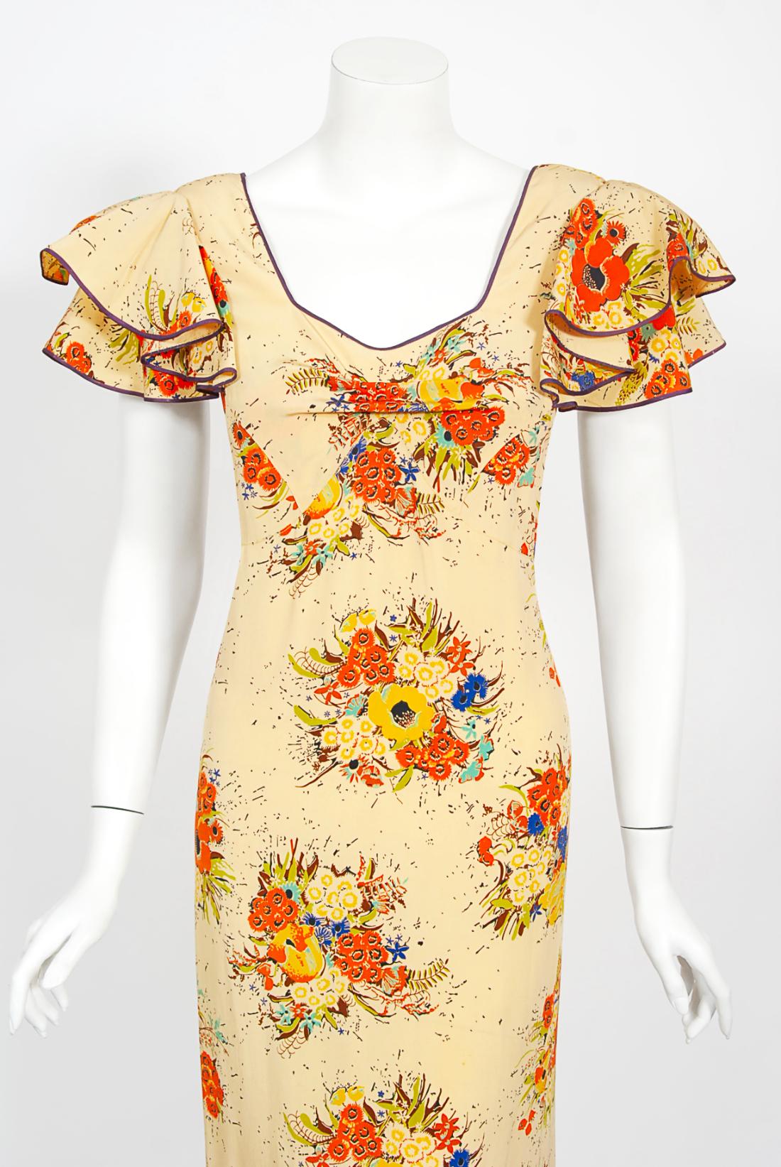 The vibrant marigold floral garden print used on this 1930's 'Ryder's of Philadelphia' designer silk maxi dress has a fresh innocence that I find irresistible. The bodice has a fantastic low-cut front with tiered short flutter-sleeves. I especially