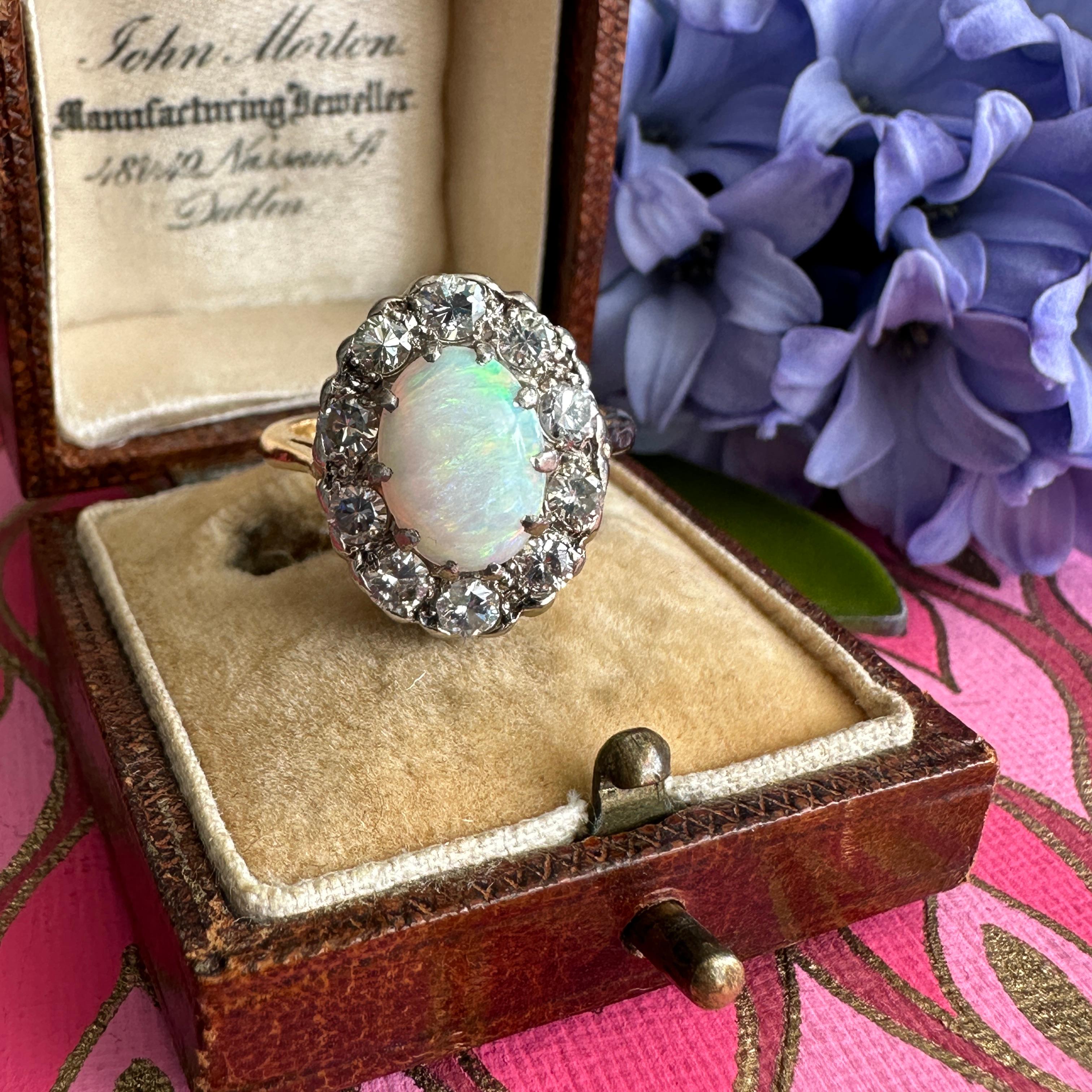 Details:
Are you looking for a fabulous Vintage Opal and chunky diamond halo ring from the 1930's? Look no further, we have your ring! This fabulous ring has a beautiful full spectrum opal with blue, green, orange, pinks. The stone is in great