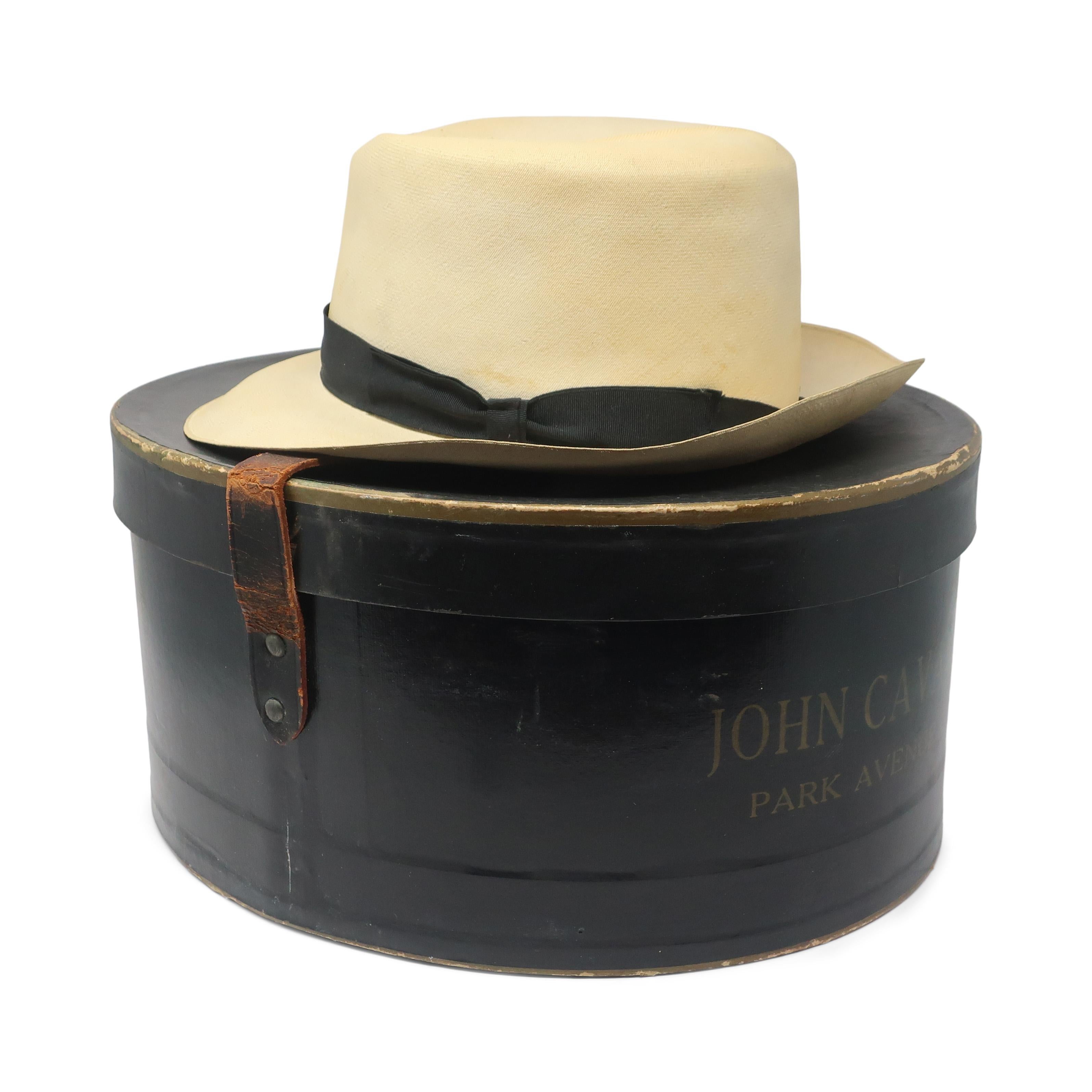 Look no further for a classic and elegant accessory than this vintage Panama hat by John Cavanagh, one of the most renowned hat-makers in American history who reshaped and influenced the design of men's dress hats for decades.  This hat is made of