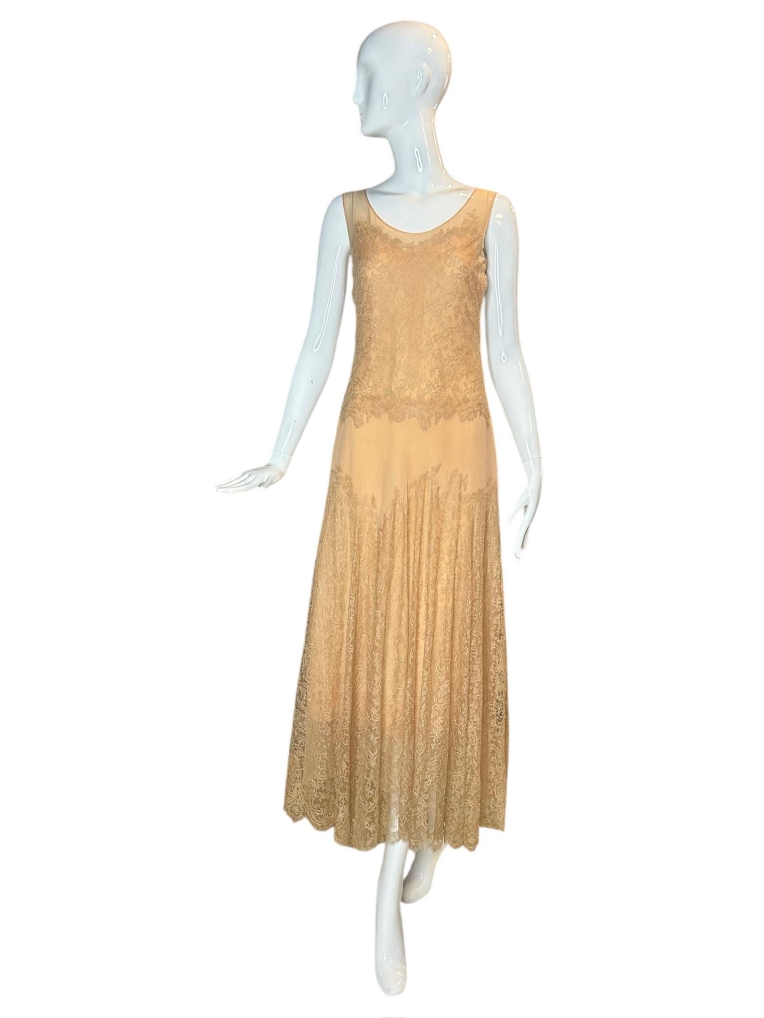 Als exquisites Beispiel für die Handwerkskunst der frühen 1930er Jahre fängt dieses Kleid aus pfirsichfarbener Spitze und Seidenchiffon die ätherische Eleganz und die fließende Silhouette der Art-Déco-Ära ein. Das Kleid mit dem sanft geschwungenen