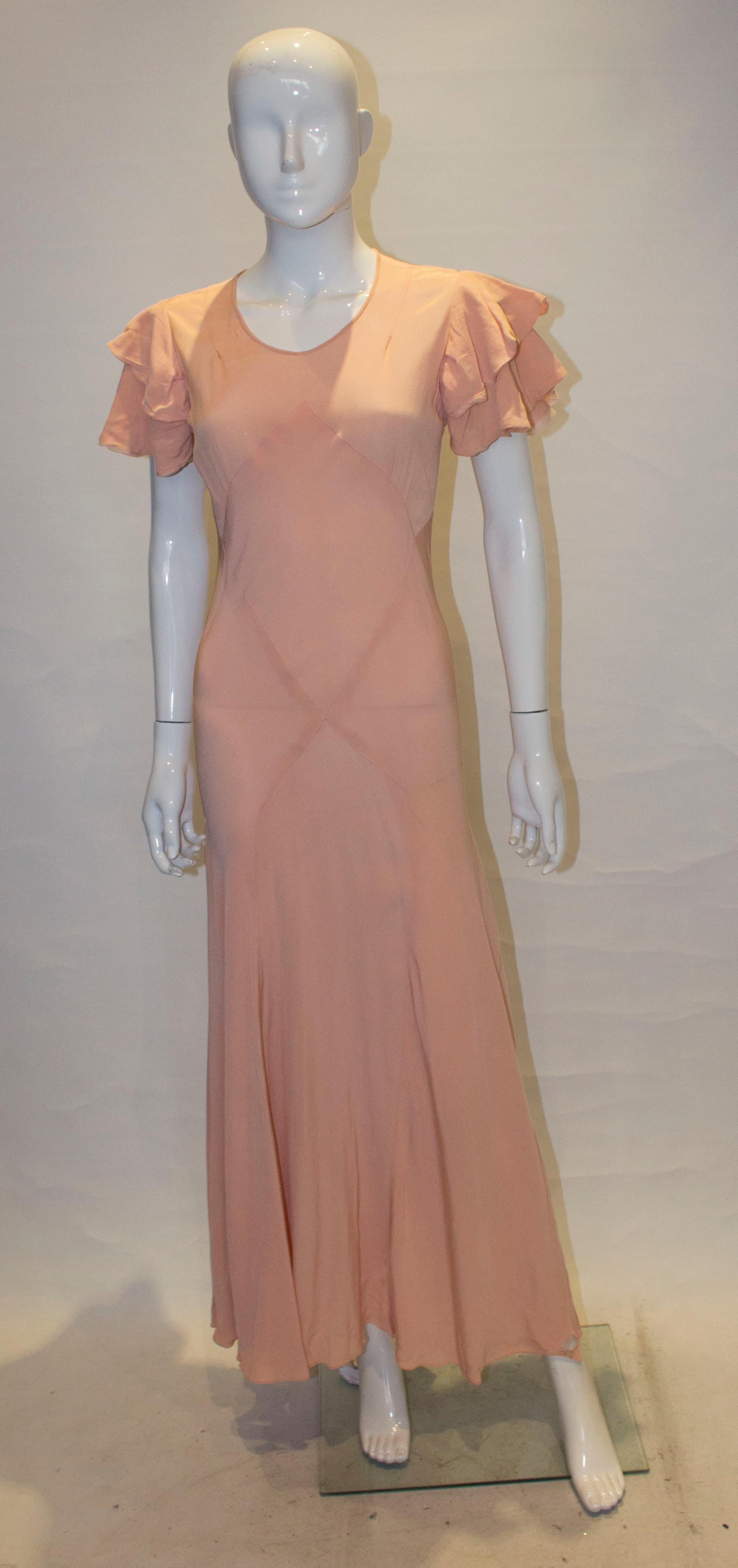 A pretty 1930s gown in pink.  The dress has two rows of ruffles on the shoulder, and hangs beautifuly. 