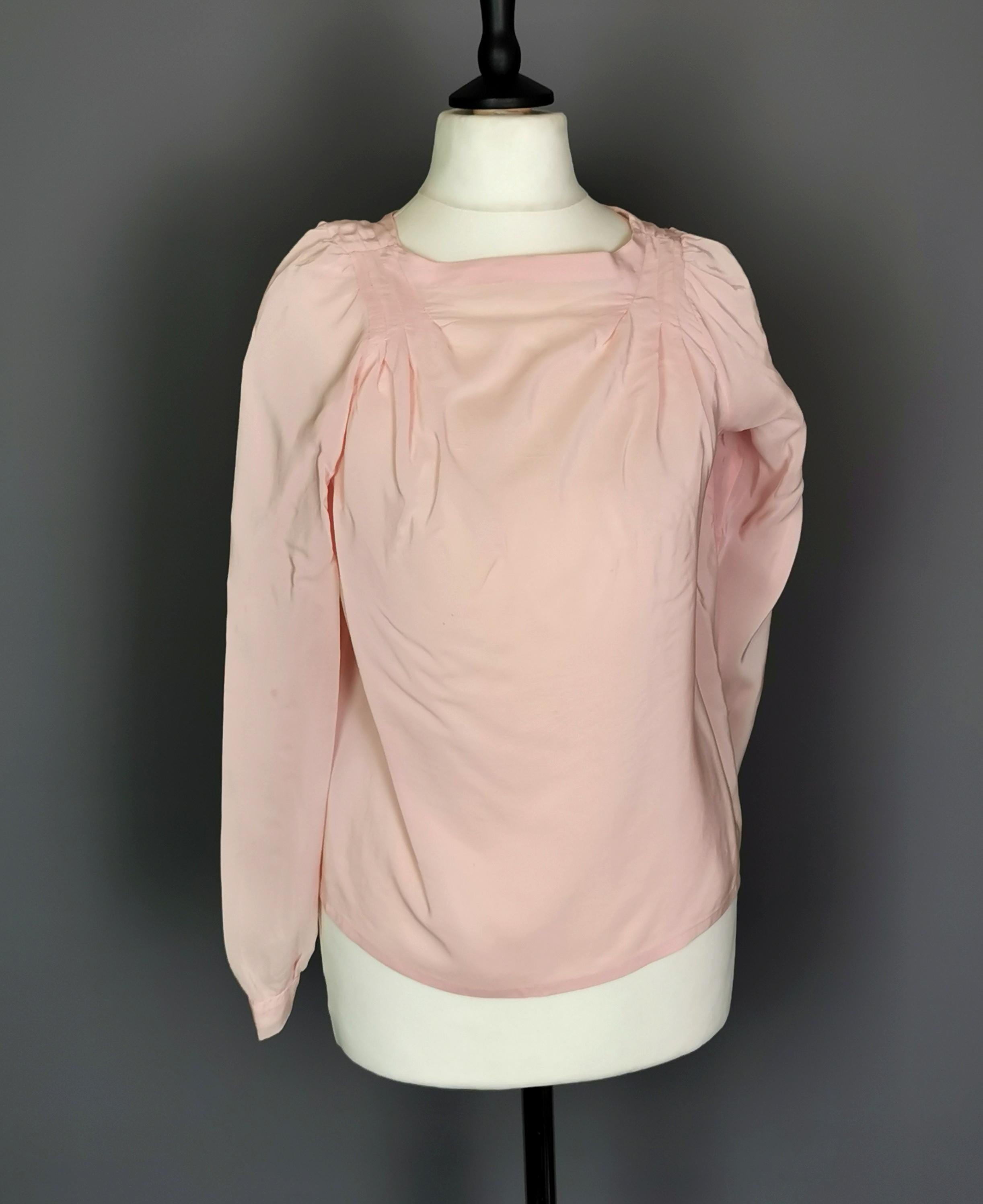 A gorgeous vintage 1930's rosebud pink silk blouse.

This is such a pretty and feminine blouse, it has slightly ruched shoulders with a pin tuck design near the shoulders and running down to the pits.

It buttons up the back and has button cuffs, it