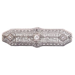 Spilla vintage anni '30 in platino filigranato con diamante a barretta