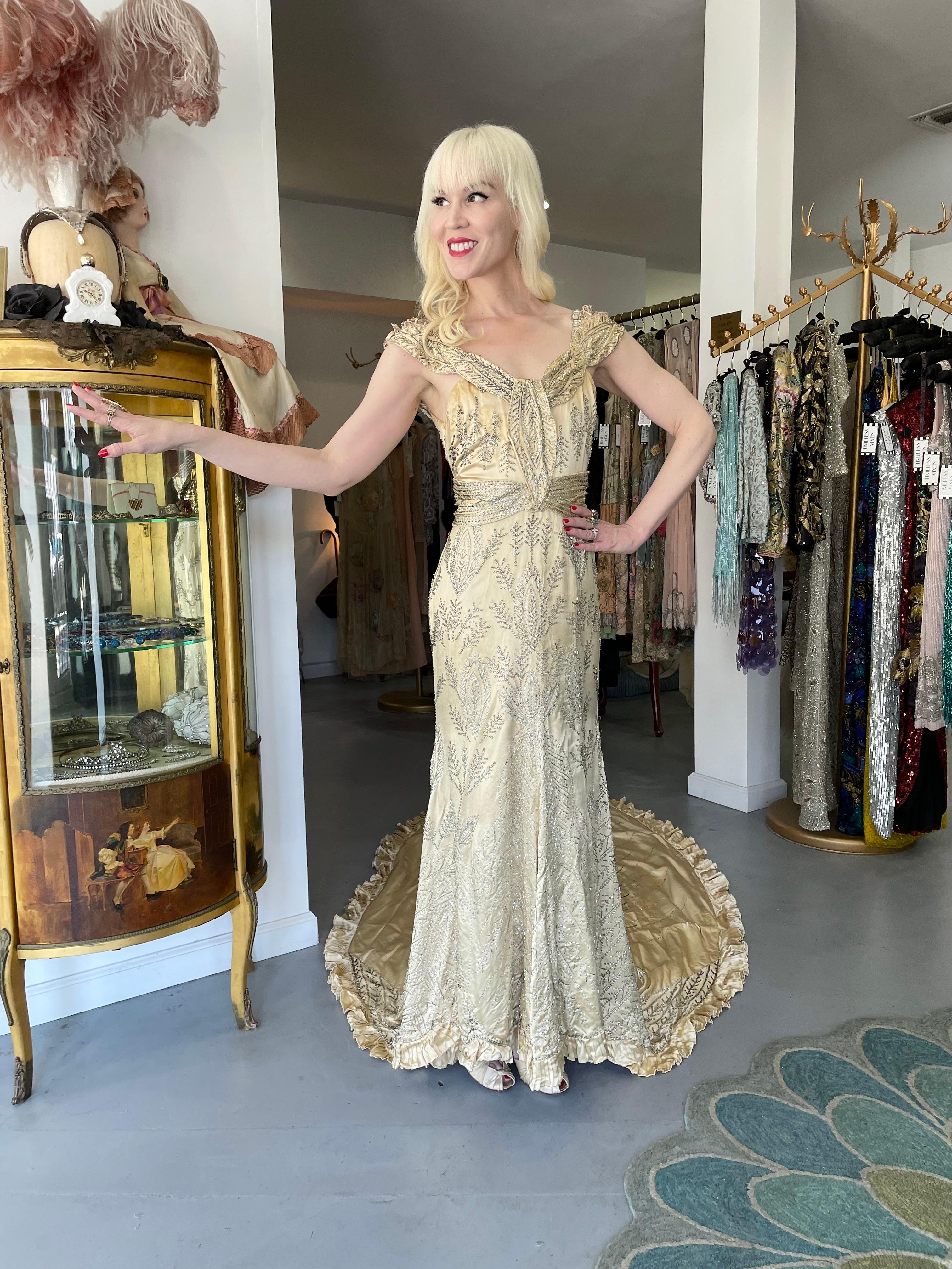 An absolutely breathtaking and incredibly rare candlelight liquid silk satin trained custom couture gown dating back to the 1930's Old Hollywood era of glamour. So Jean Harlow! The fabric itself is a masterpiece; luxurious silk satin with hundreds