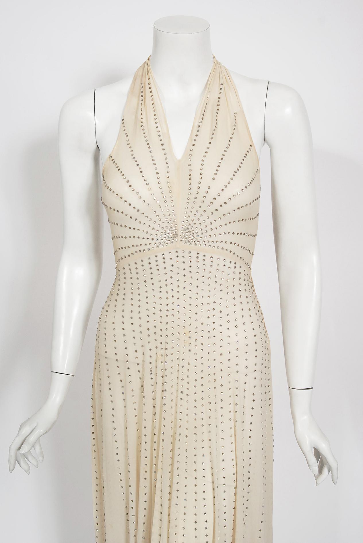 A breathtaking ivory sheer silk chiffon gown dating back to the late 1930's Old Hollywood era of glamour. So Ginger Rodgers! I have never seen such a romantic design; hundreds of sparkling prong-set rhinestones in an alluring deco motif. The bodice