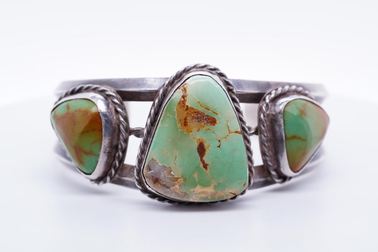 Vintage 1930s Royston Navajo Green Turquoise Sterling Cuff Bracelet
Early Royston jewelry was not signed.
No Stamp on inside.
Center Turquoise stone measures: 23 x 38 mm
Total Weight: 58.53 grams of sterling silver and turquoise.
Size: small sized