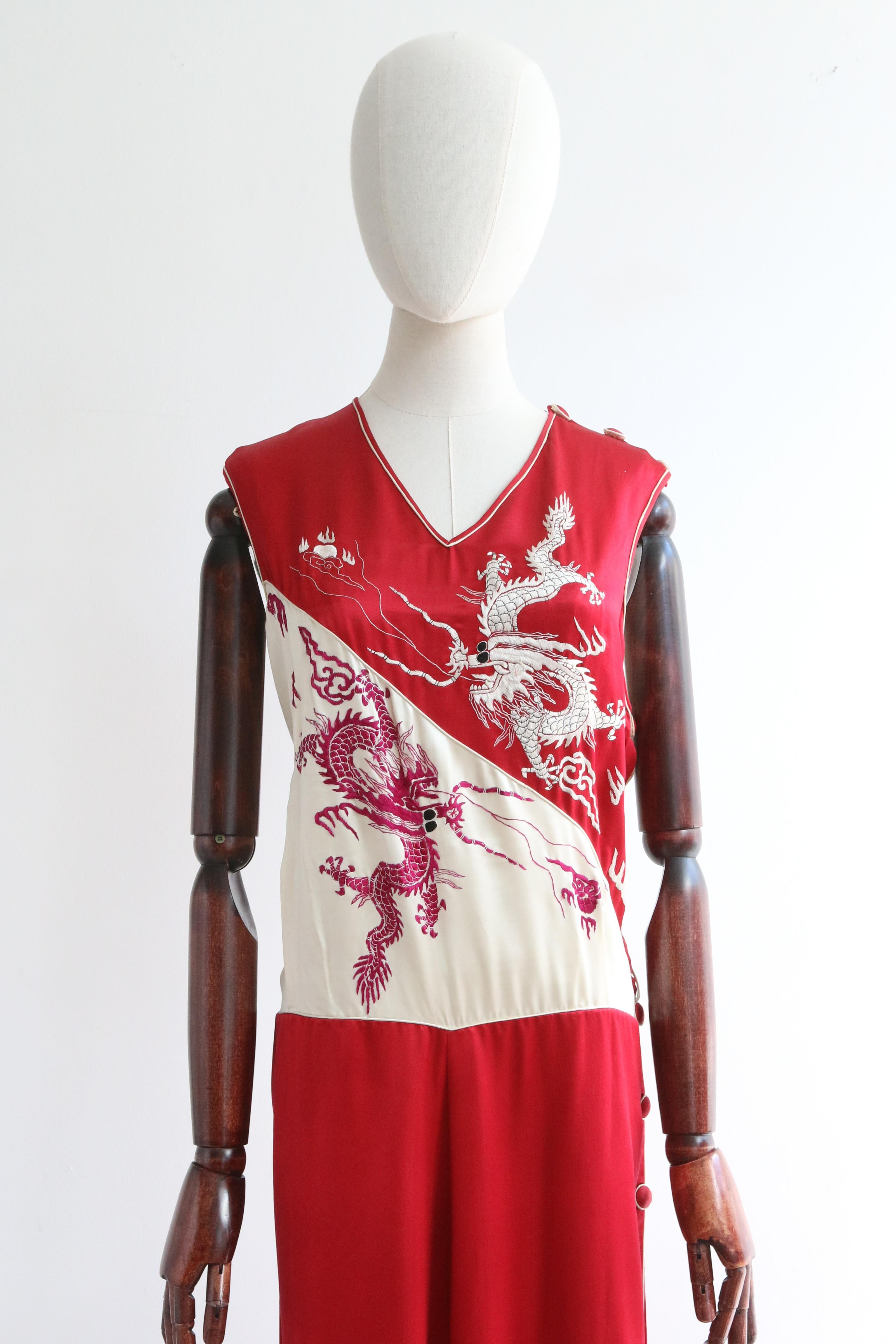 A rare piece to behold and never again find, this original 1930's silk jumpsuit in shades of cream, red and burgundy, decorated with embroidered dragons, is the perfect statement piece for your loungewear wardrobe. 

The V shaped neckline is framed