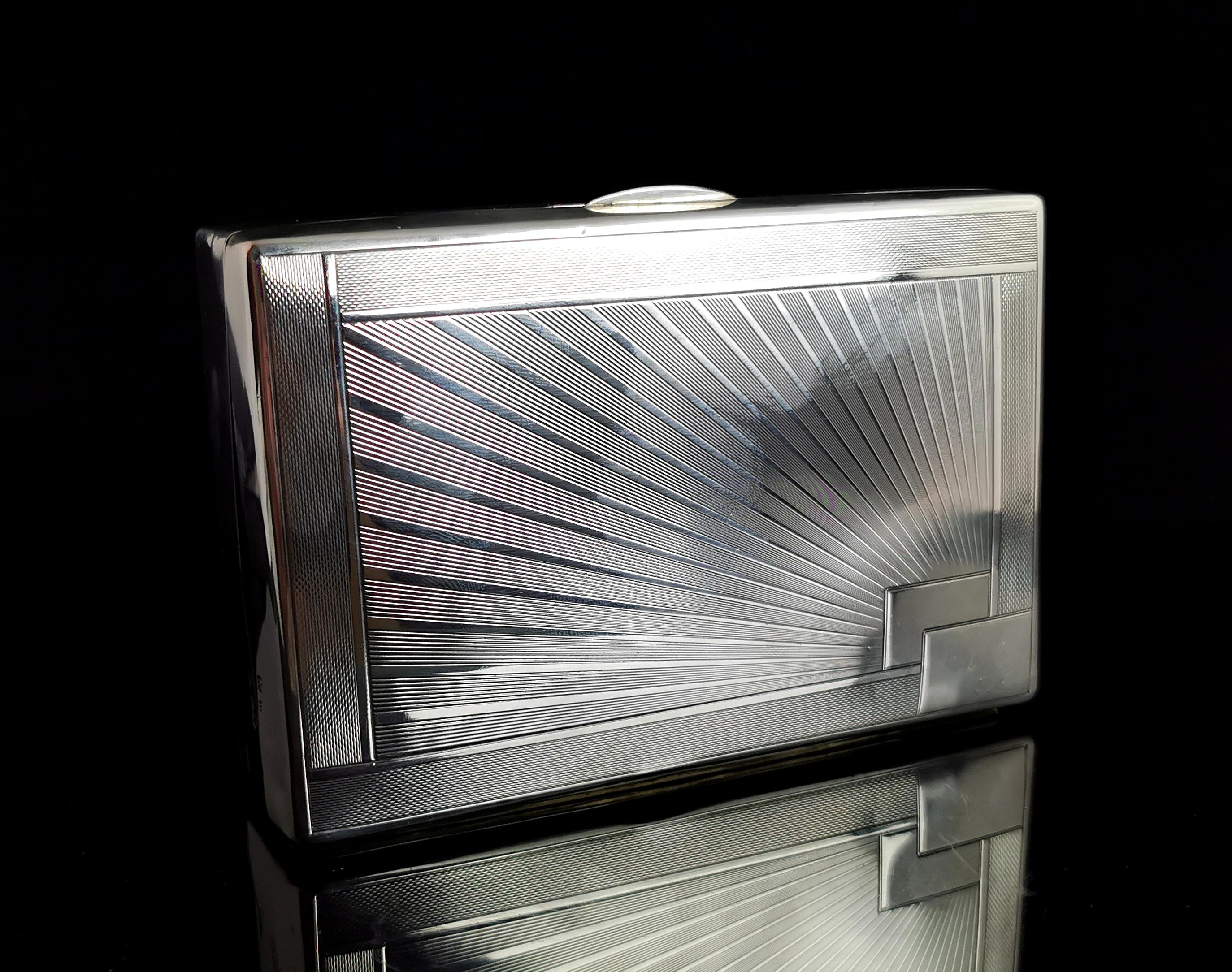 An attractive vintage 1930's sterling silver cigarette box.

Made from sterling silver with a sun ray engraved lid, in a typically Art Deco design.

It has a small rectangular plain cartouche to one corner which could be personalised if desired.

It