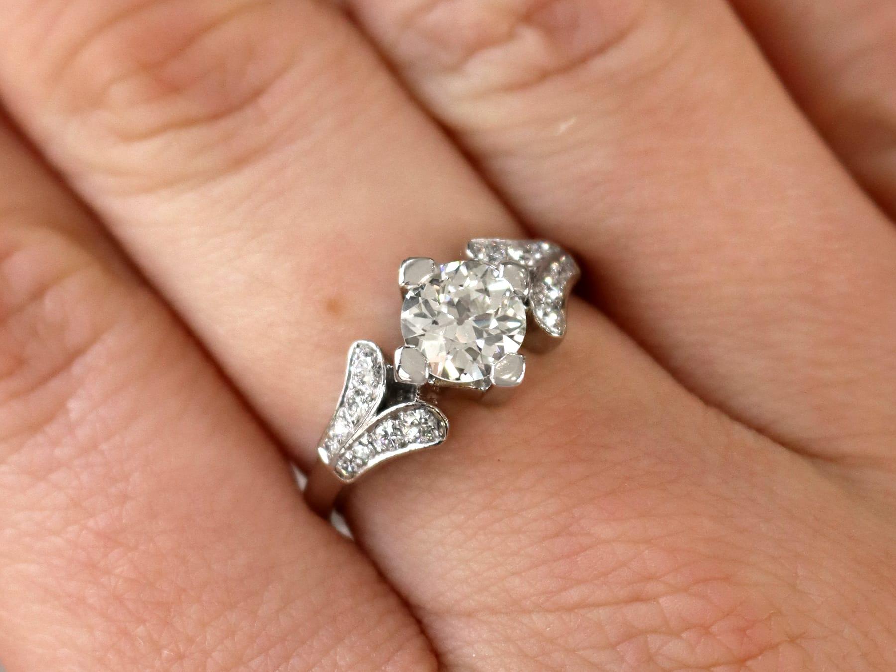 A stunning vintage 1940s 1.29 carat diamond and platinum solitaire style engagement ring; part of our diverse diamond jewelry and estate jewelry collections.

This stunning, fine and impressive diamond solitaire engagement ring with accents has been