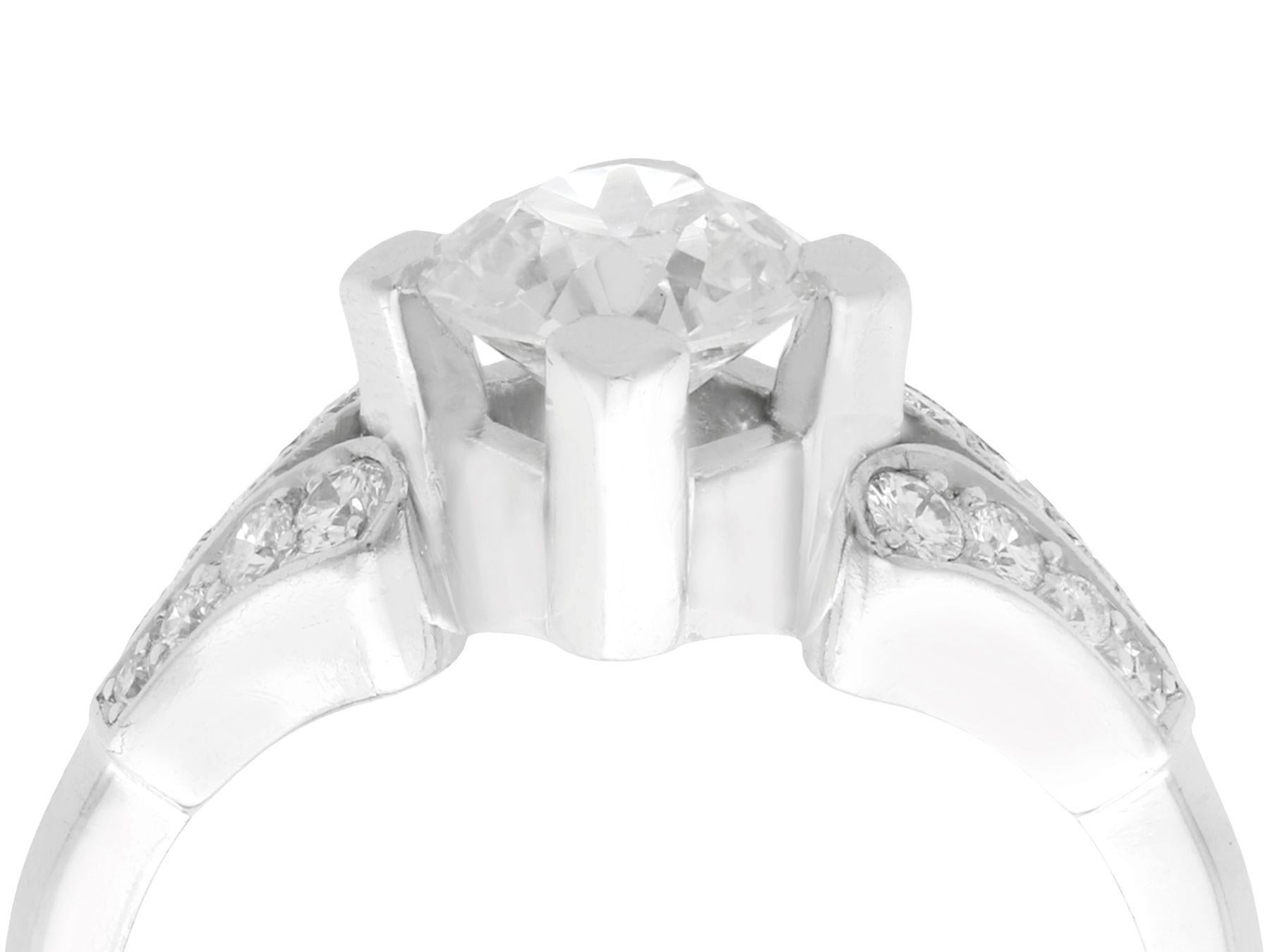 A stunning vintage 1940s 1.29 carat diamond and platinum solitaire style engagement ring; part of our diverse diamond jewelry and estate jewelry collections.

This stunning, fine and impressive diamond solitaire ring with accents has been crafted in