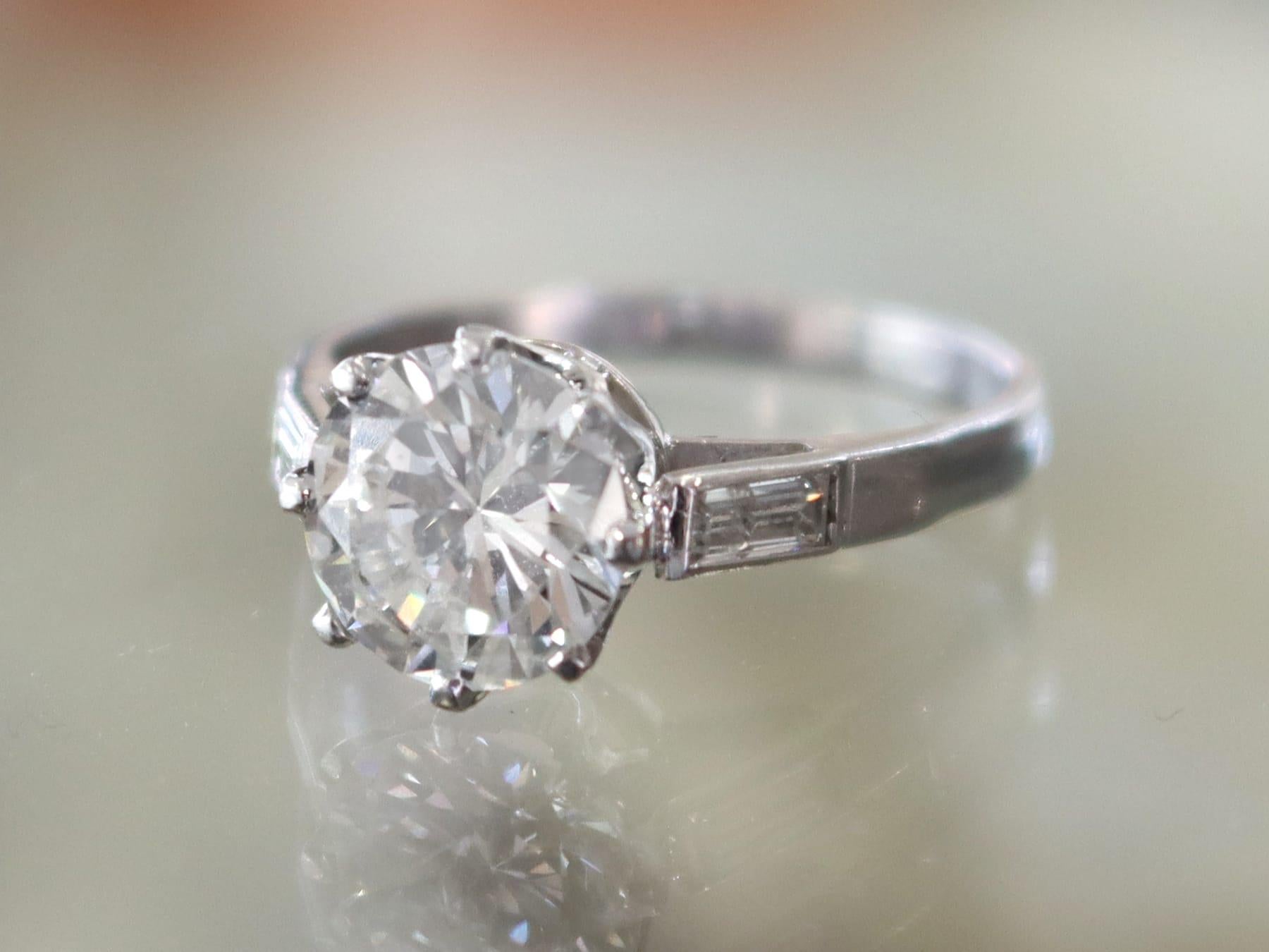 A stunning vintage 1.90 carat diamond and 18 karat white gold solitaire ring with 0.20 carat diamond accents; part of our diverse diamond jewelry collections.

This stunning, fine and impressive diamond solitaire ring with baguette cut accents has