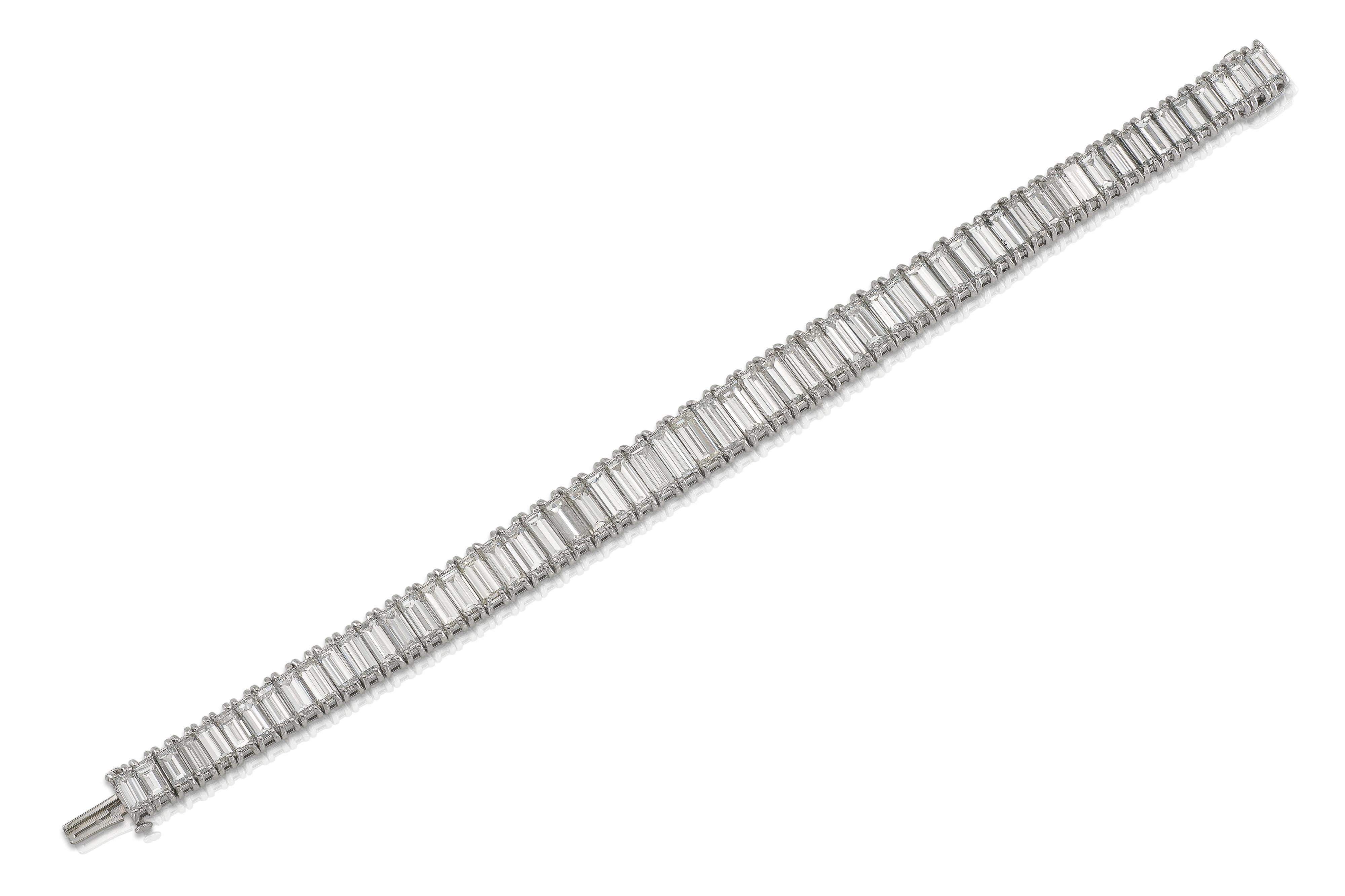 Finely crafted in platinum with 58 graduating Baguette cut Diamonds weighing approximately a total of 40.00 carats, F-J color, VS1-SI2 clarity.
Size 7 1/4 inches
Circa 1940s