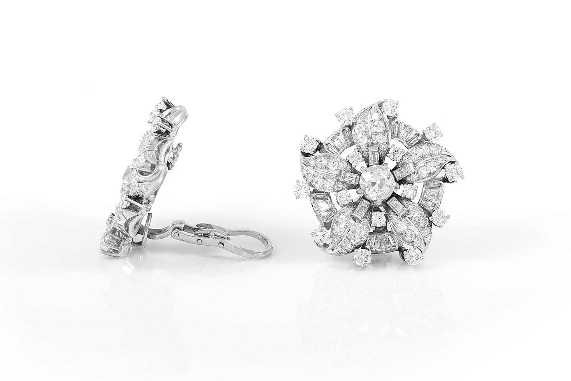Finely crafted in platinum with two Old European cut center Diamonds weighing a total of approximately 2.00 carats, J-L color, VS1-VS2 clarity. The earrings feature smaller Old European, Single, and Baguette cut Diamonds weighing a total of