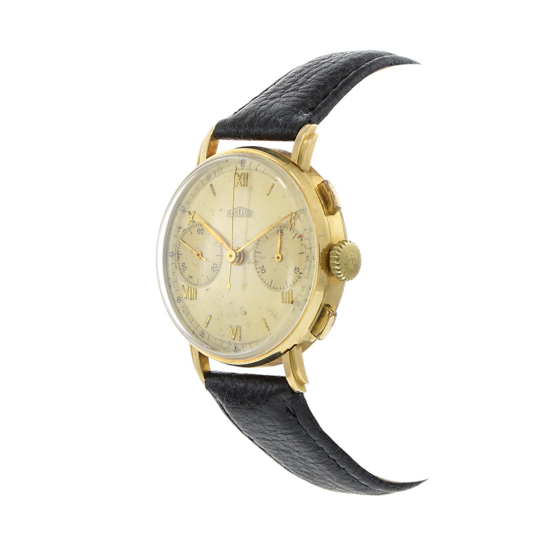A rare and elegant 1940s Angelus Watch Co. Swiss chronograph, featuring a 35.5mm 18K yellow gold case that embodies classic mid-century design. The silver dial has developed a beautiful patina over time, enhancing its vintage character, and is