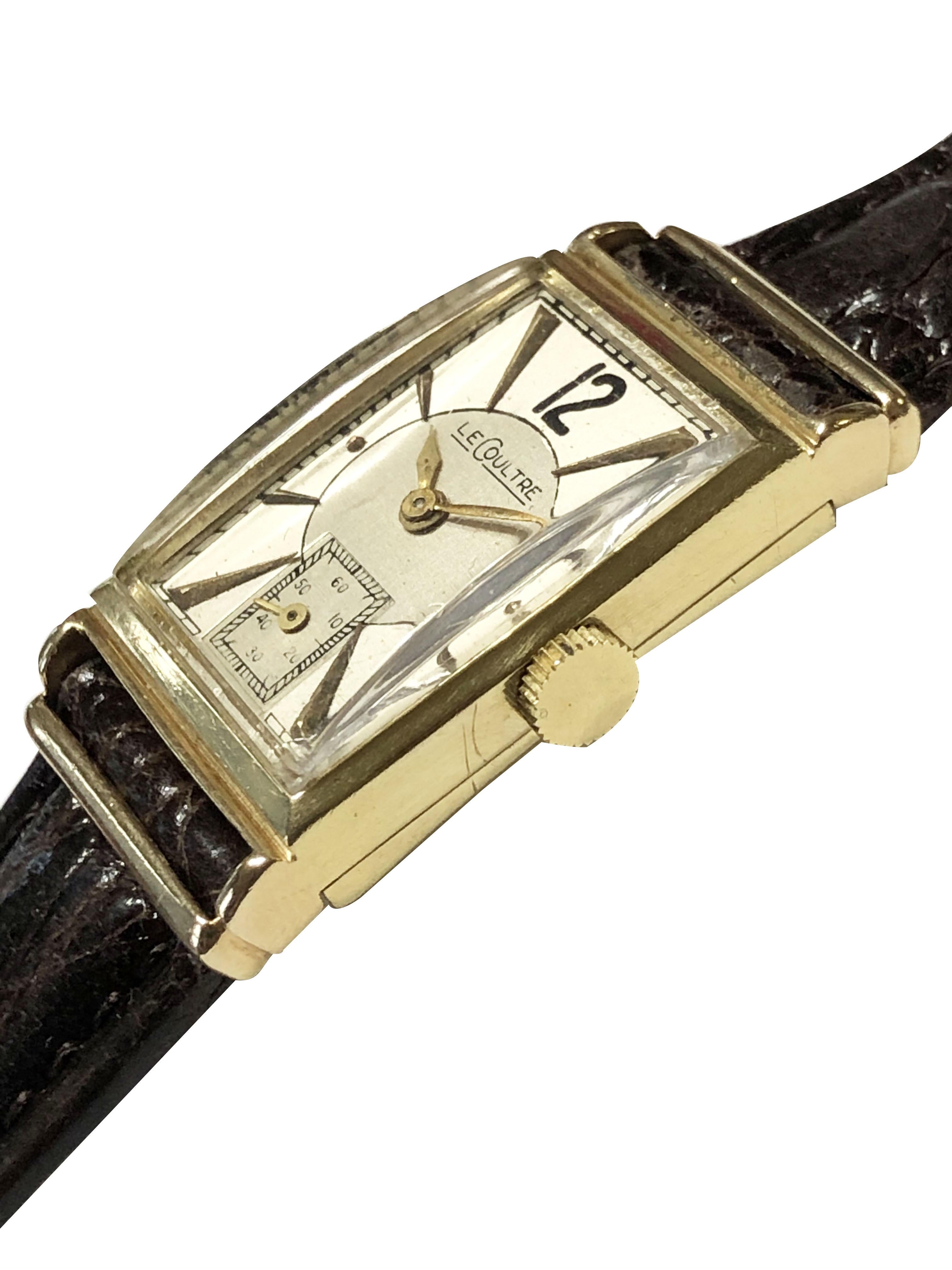Circa 1940s LeCoultre  Art Deco Wrist Watch, 38 X 20 M.M. 14K Yellow Gold 2 Piece Rectangular case, 17 Jewel Mechanical, manual wind nickle lever movement. Silver Satin two tone dial with raised Gold markers and a sub seconds chapter. New Brown