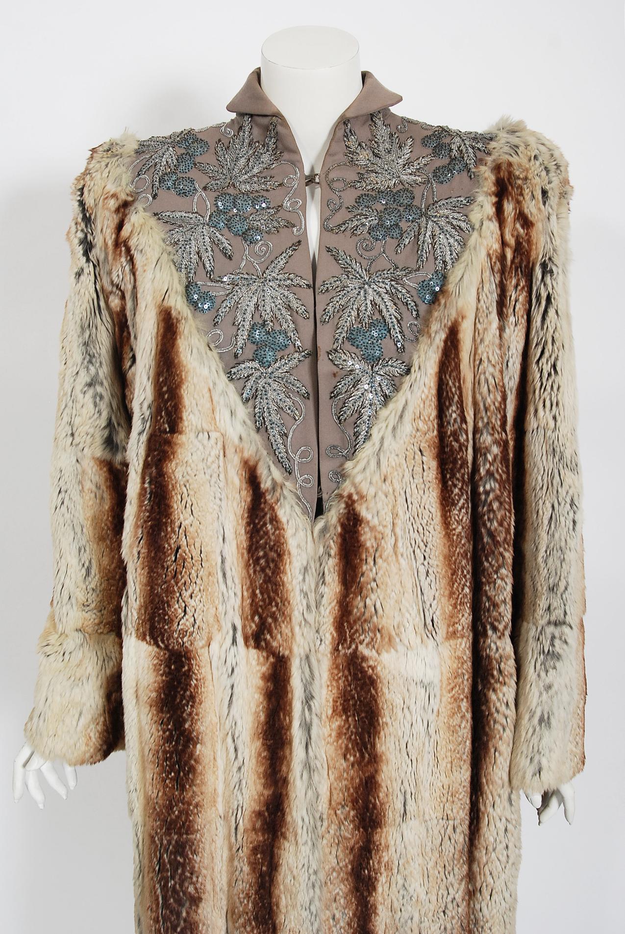 This unbelievable, museum-quality early 1940's European embroidered gabardine & genuine chinchilla fur coat is a breathtaking piece of fashion history. The care to piece a full-length chinchilla coat together after carefully selecting matching hues