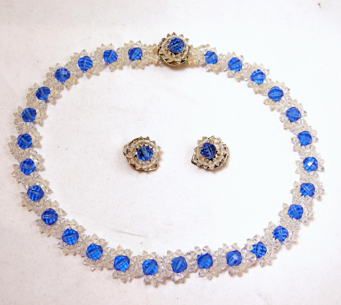 This 1940s vintage necklace & earrings set has clear glass beads going completely around the neck. Blue crystal beads are in the center of each glass link … in a silver tone setting.  In excellent condition, the necklace measures 17” x 5/8” with a