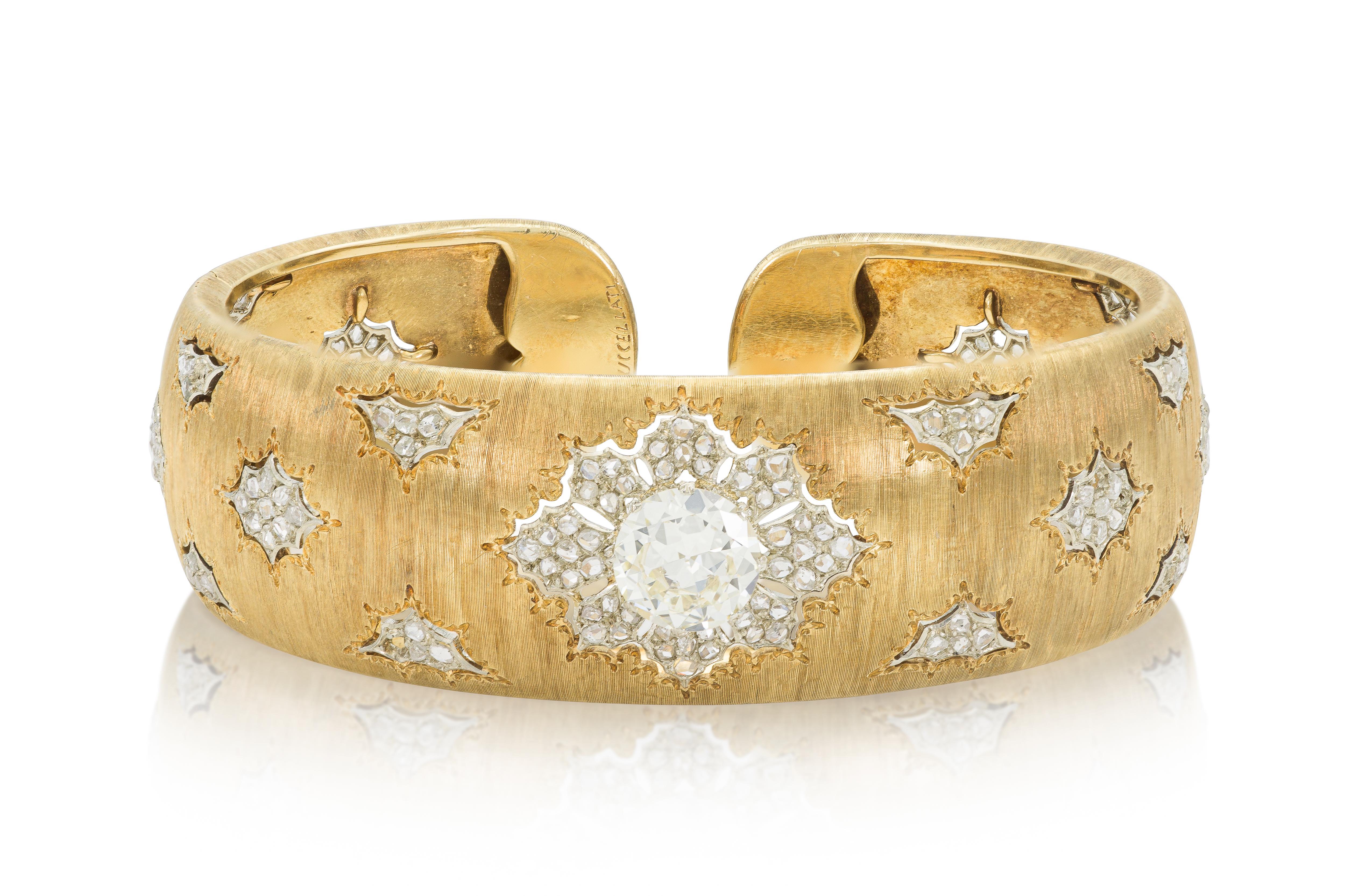 Finely crafted in 18k yellow gold with an Old European cut Diamond weighing approximately 2.00 carats and small Rose cut Diamonds.
Signed by Buccellati
Circa 1940s
Size 6 1/4 inches, 3/4 inch wide