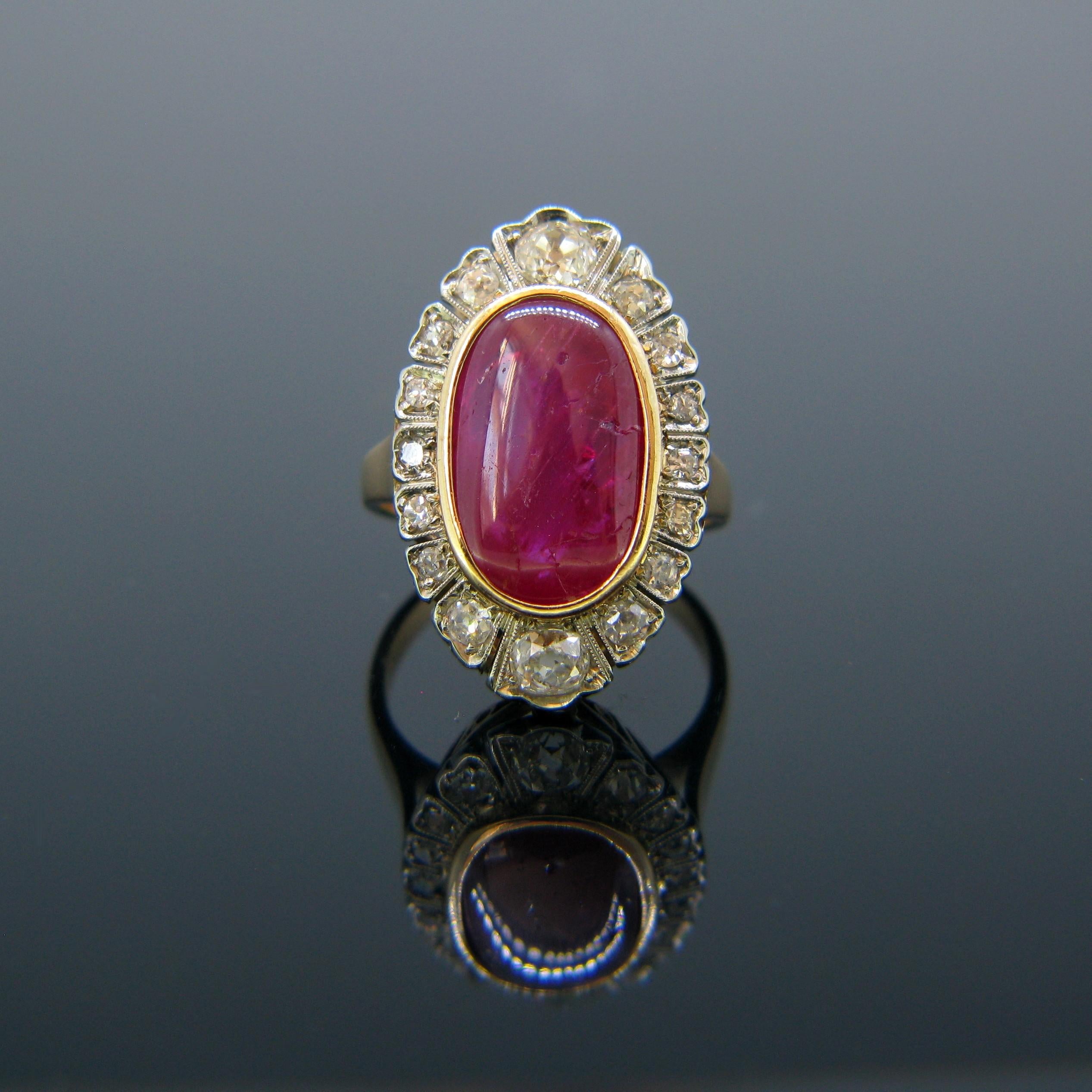 This vintage ring is set with a 10ct Ruby Cabochon and is surrounded with 16 diamonds – old cut and single cut. The diamonds are set in platinum and the rest of the ring is in 18kt rose gold. It was made circa 1940s. The cabochon shows fissures due