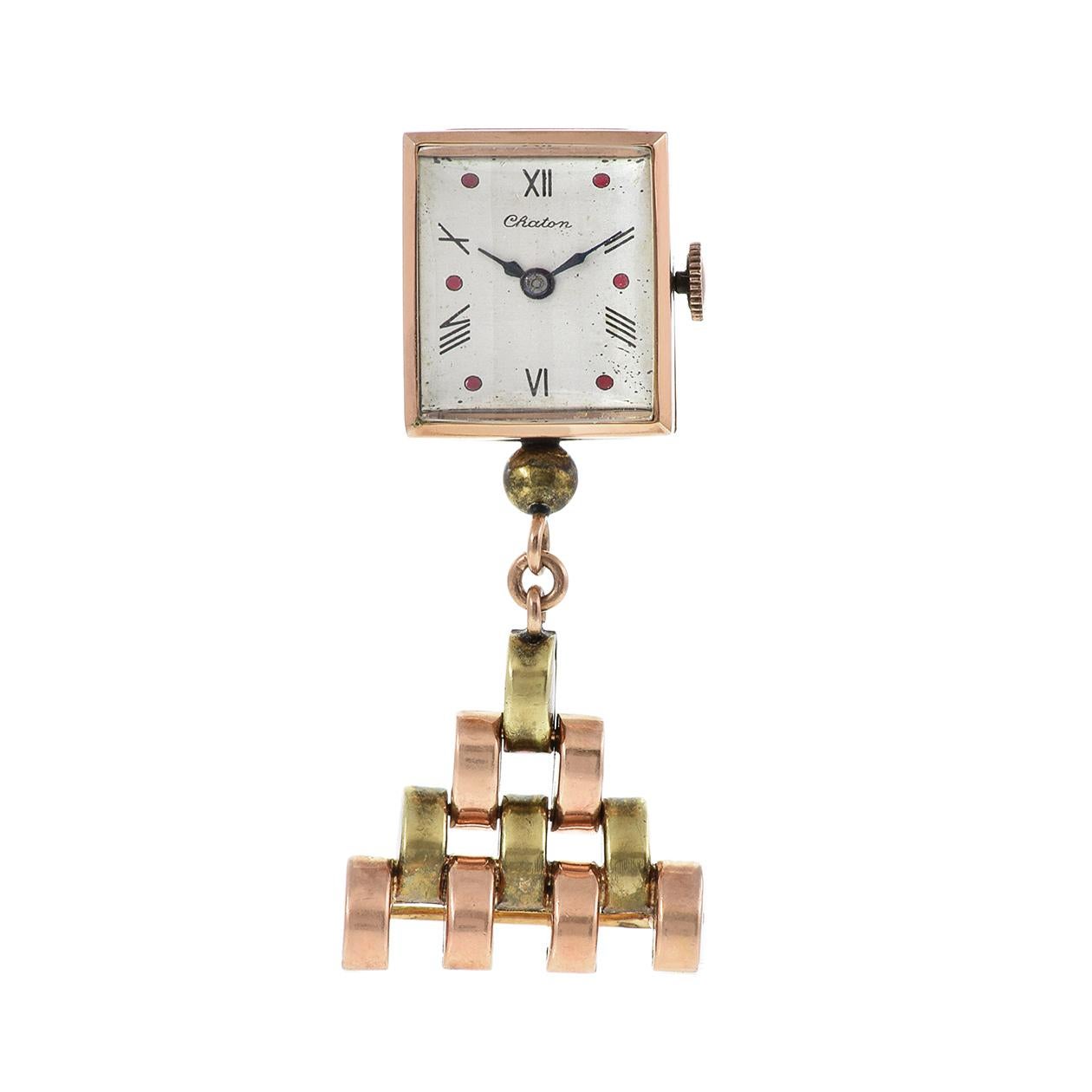 The Chanton pin watch from the 1940s, a true relic of timeless elegance, boasts distinctive features that make it a standout vintage timepiece. Encased in a 17 x 20mm 14KT rose gold casing, the watch showcases a white dial adorned with hand-painted