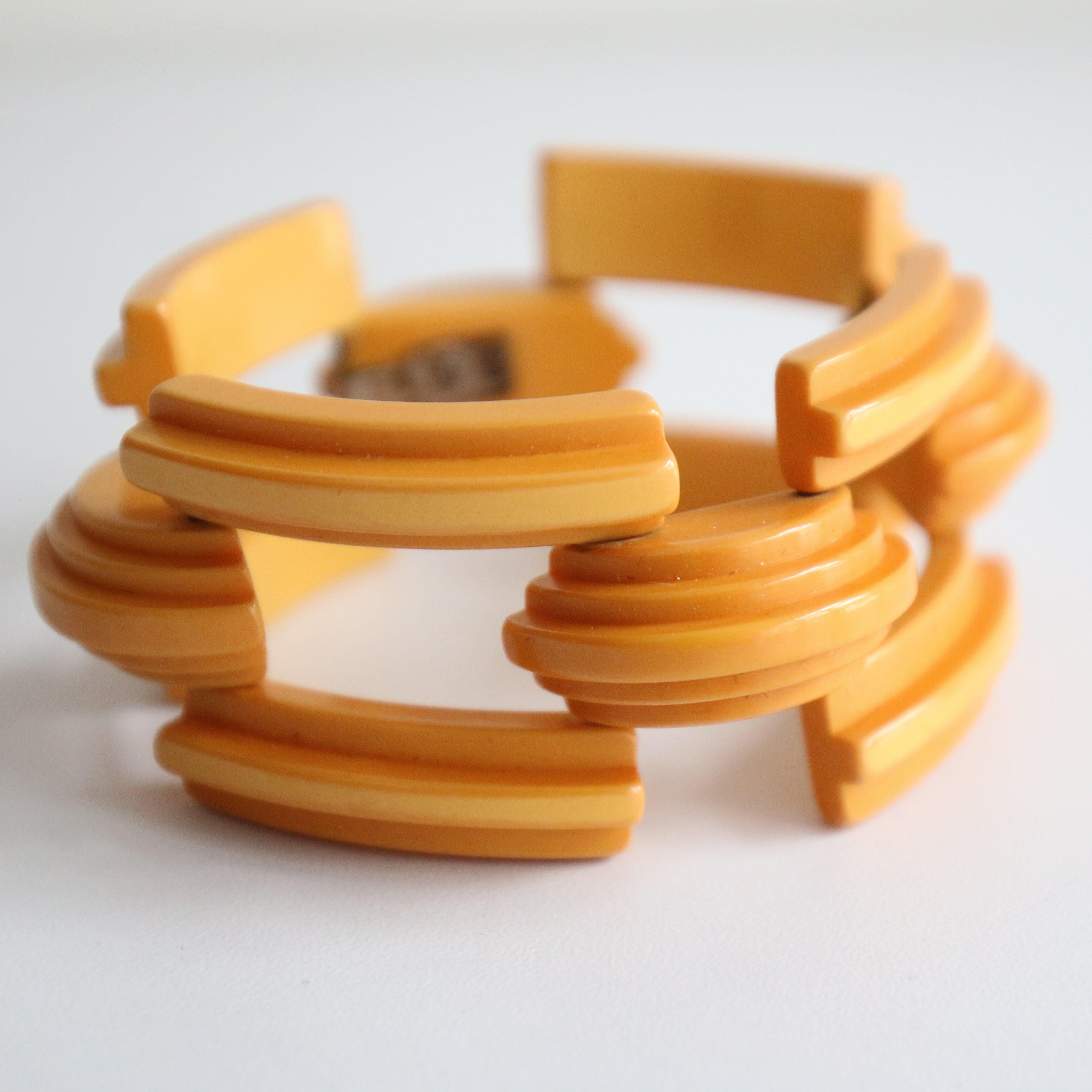 This eye-catching 1940's yellow curved and ridged bakelite bracelet, in a wonderful geometric design, is the perfect finishing touch to your outfit.


Width: 1.3 inches

Length: 7.5 inches

Closed Circumference: 7 inches

Clasp: Hook

Material: