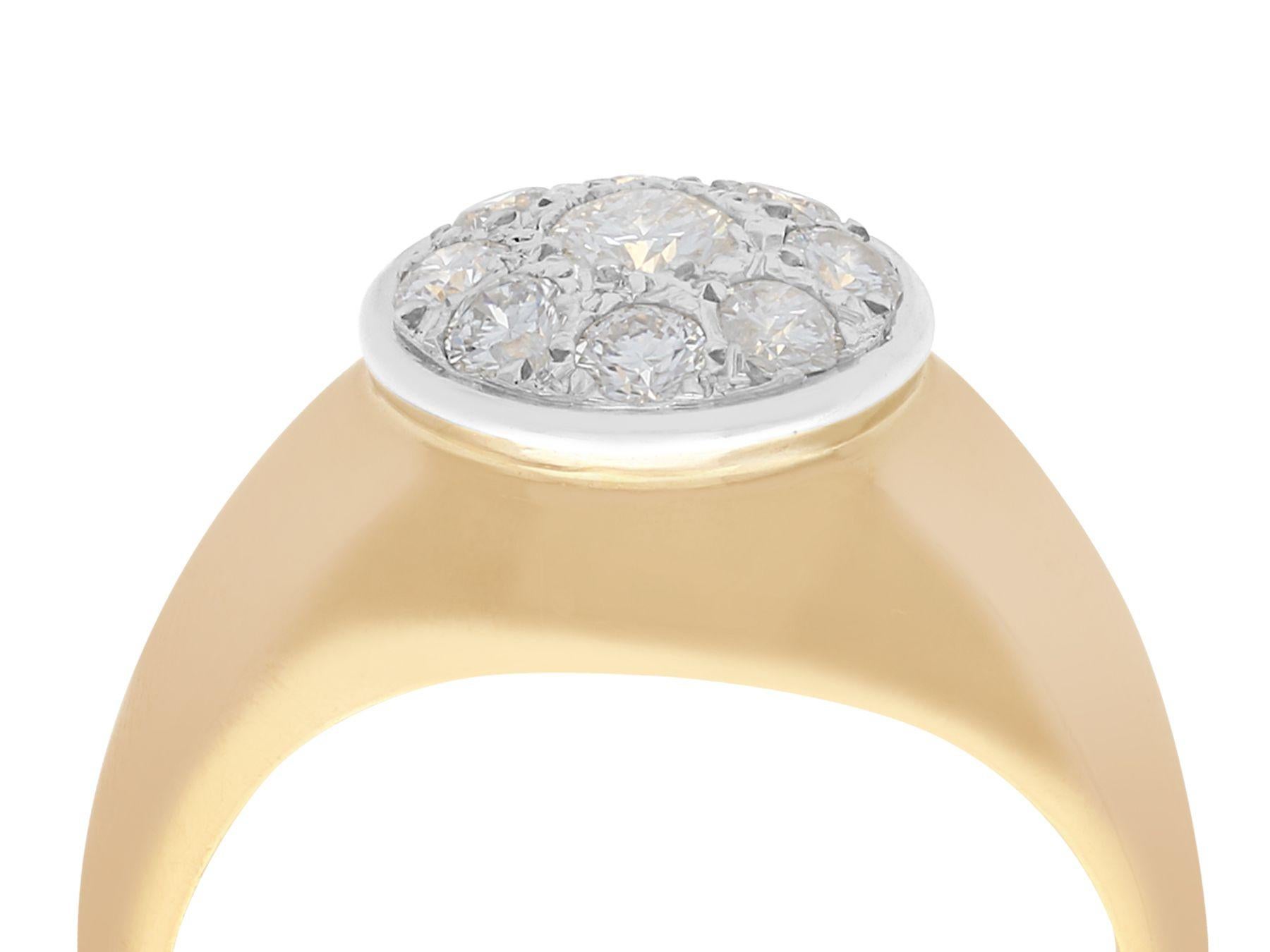 A fine and impressive 0.98 carat diamond, 18 karat yellow gold and 18 karat white gold cluster ring; part of our diverse vintage jewelry collections.

This fine and impressive diamond cluster ring has been crafted in 18k yellow gold with an 18k
