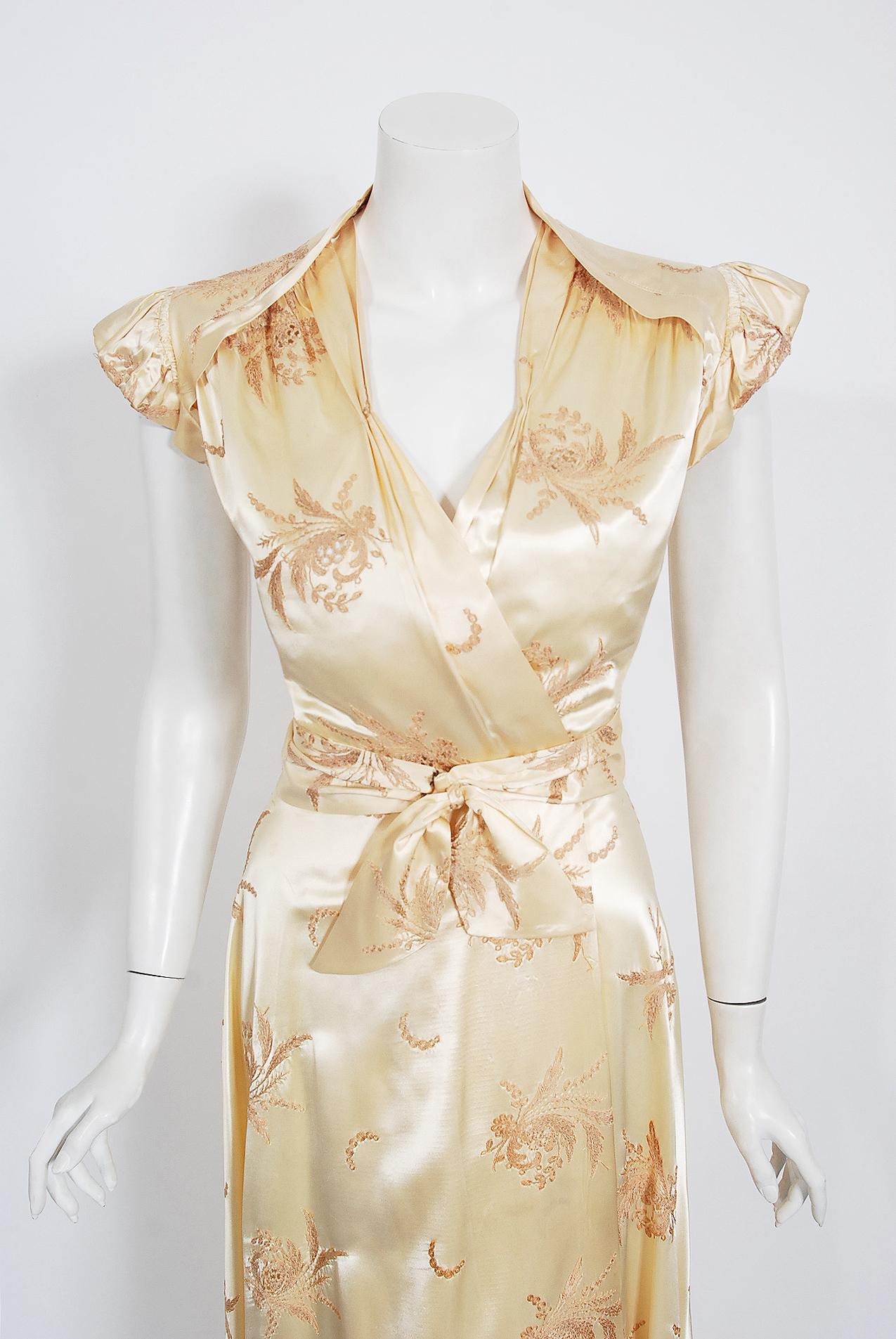 The breathtaking embroidered creme silk-satin used for this 1940's dressing gown has a fresh innocence that I find irresistible. The bodice has a flirty low-cut plunge and the most beautiful winged cap-sleeves. Love the cut-out details which show