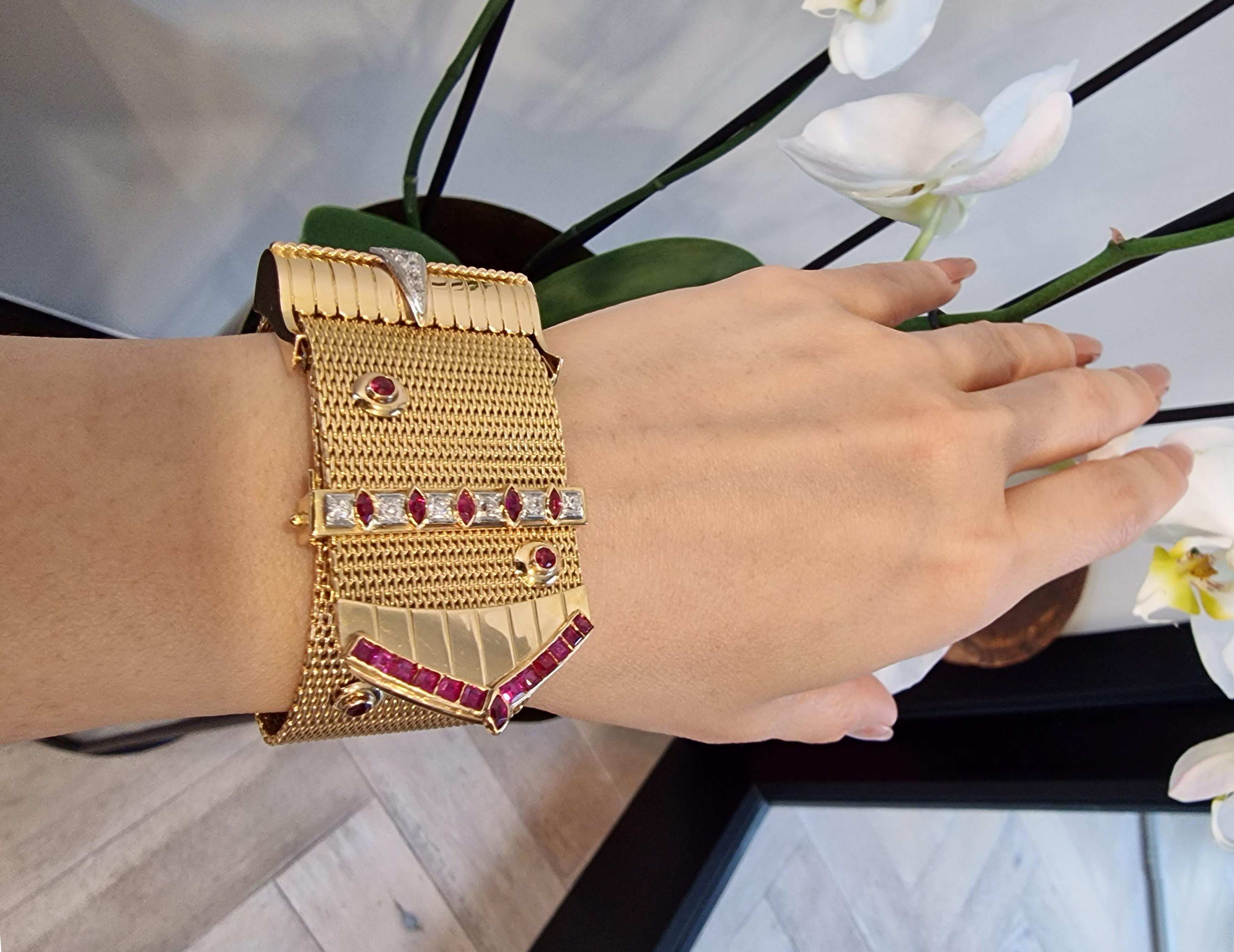 A statement piece, this heavy 18ct yellow gold mesh bracelet is studded with rubies and diamonds.  An unusual vintage piece that is one of a kind.

With a length of heavy gold mesh featuring two alternating rows of dome-shaped faceted rubies held in