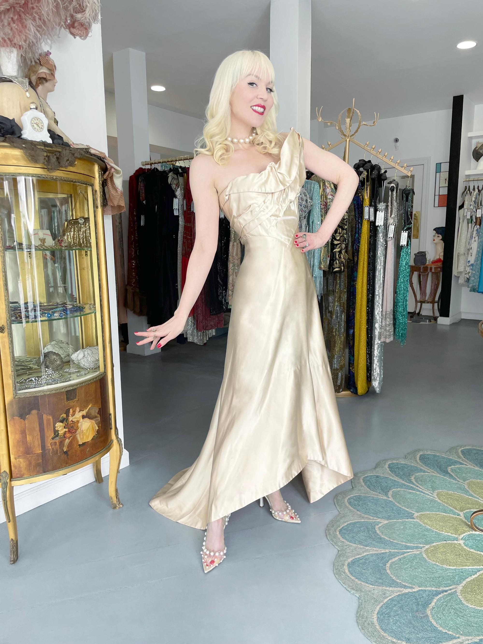 A highly coveted and incredibly glamorous Irene Lentz custom couture candlelight cream gown dating back to the late 1940's. Irene Lentz stunned the world in the 1930's, 40's and 50's with her ingeniously constructed, sophisticated, couture-standard