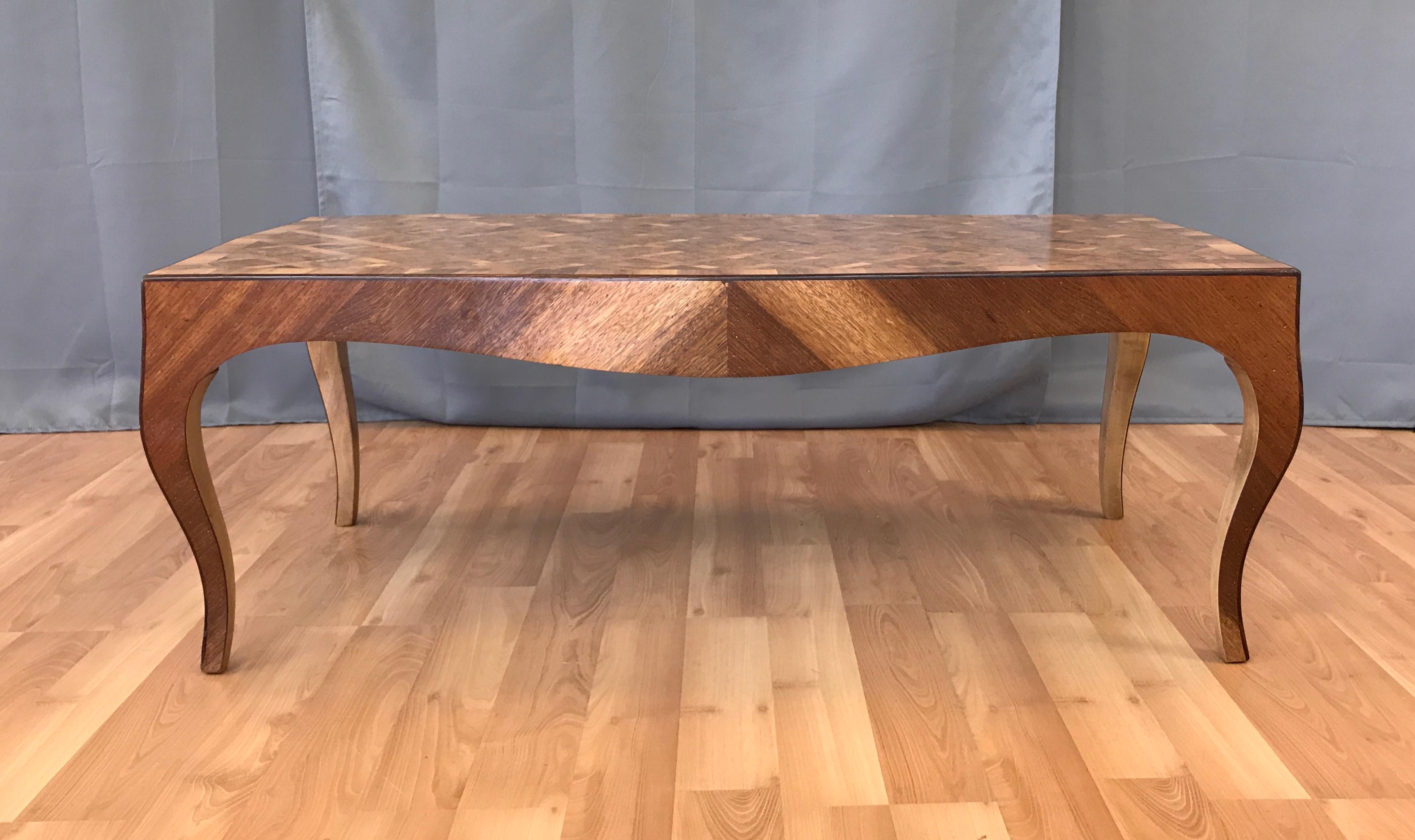 Offered here is a vintage 1940s Italian marquetry coffee table.

this example features intricately grained elmwood burl squares bordered with fruit wood (pecan?) on a diagonal pattern. The Pecan wood boarder and skirt finish in graceful cabriole