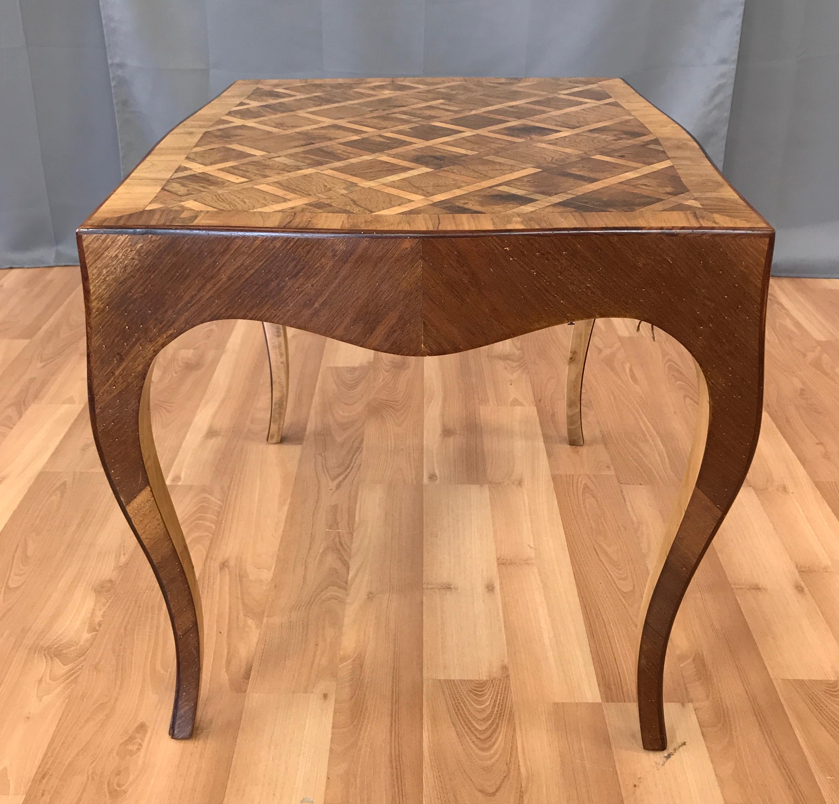 Offered here is a vintage 1940s Italian marquetry end table.

This example features intricately grained elmwood burl squares bordered with fruit wood (pecan) on a diagonal pattern. The same fruit wood boarder comprises the apron and delicate