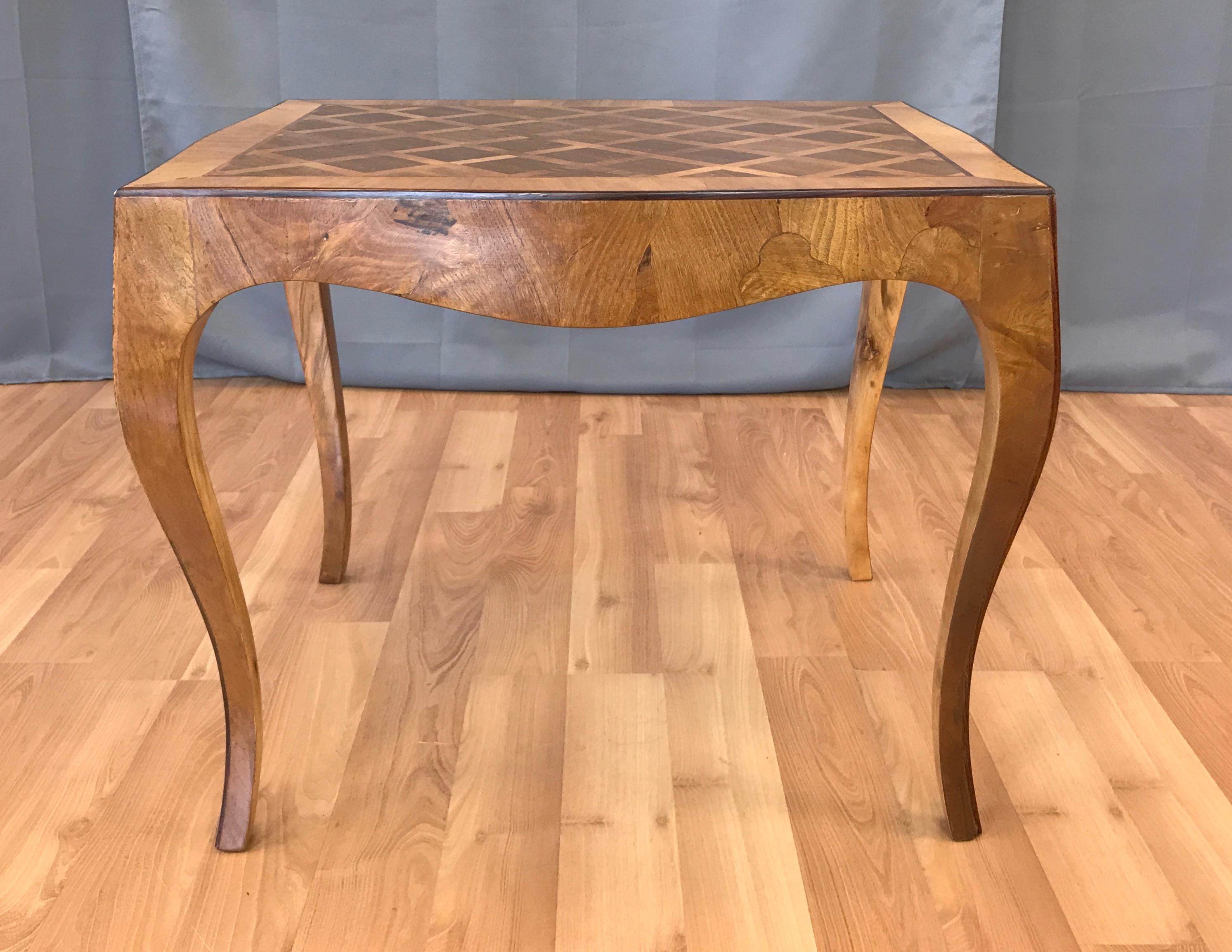 Offered here is a vintage 1940s Italian marquetry end table.

This example features intricately grained dark walnut bordered with a light colored satin wood boarder with a diagonal pattern. The apron and delicate cabriole legs are a blonde maple