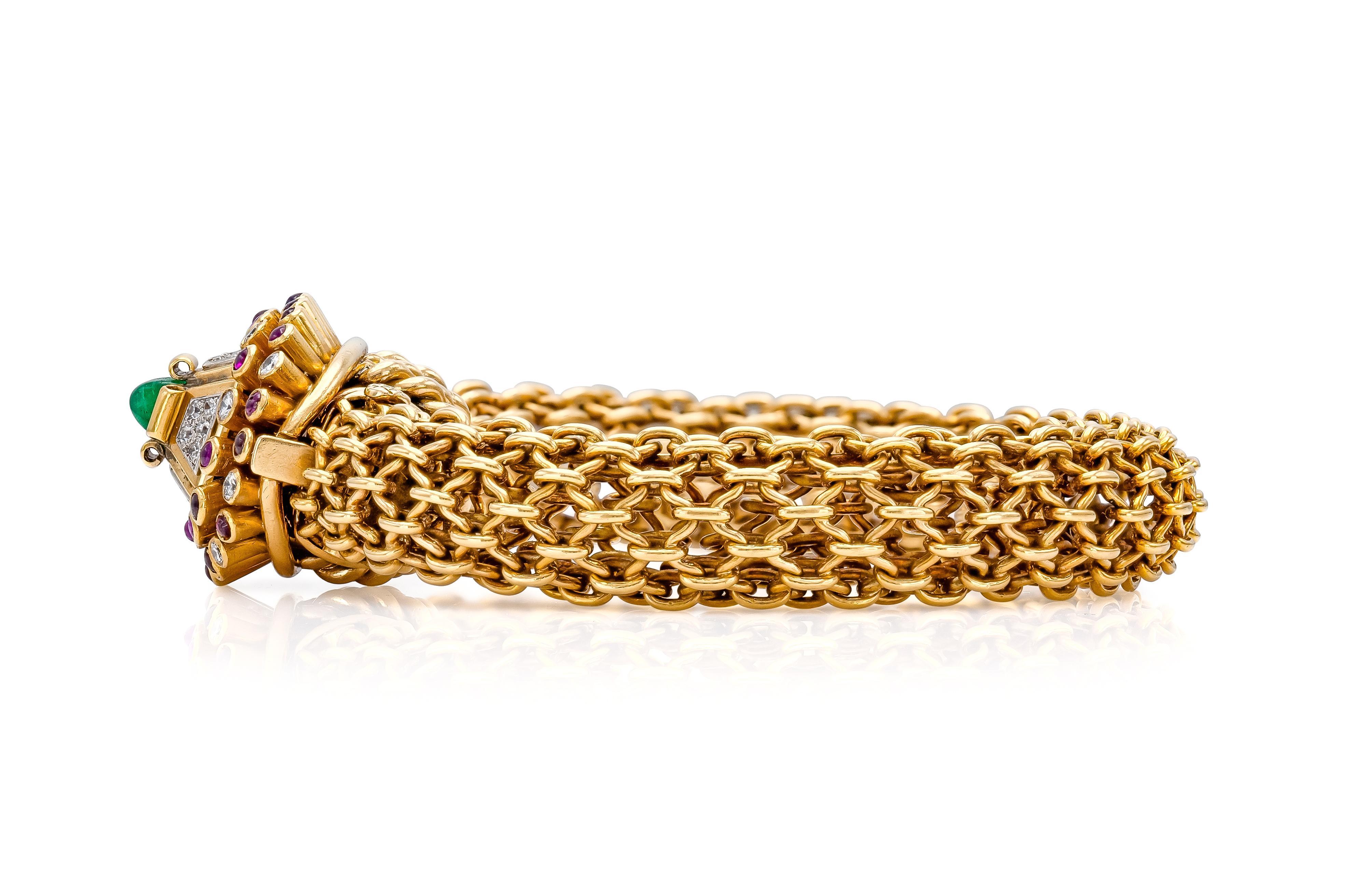 Finely crafted in 18k yellow gold with Round Brilliant cut Diamonds, Cabochon Rubies, and a Sugarloaf Emerald in the center.
Signed by Marchak
Circa 1940s
8 x 1/2 inches. Fits like 6 1/2 inches