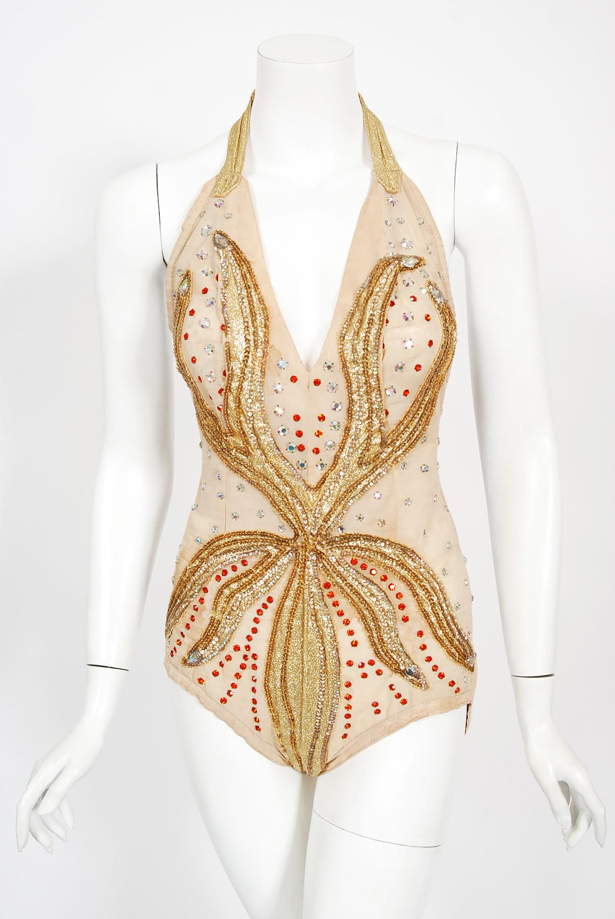 A truly unique and ultra seductive metallic gold lamé fire-flame showgirl circus dance costume dating back to the mid 1940's. This sensational showstopper is beautifully constructed with sparkling metallic gold lamé appliqued on a high-quality