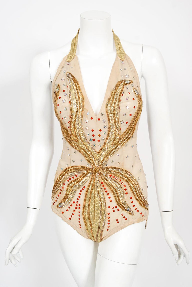 A truly unique and ultra seductive metallic gold lamé fire-flame showgirl circus dance costume dating back to the mid 1940's. This sensational showstopper is beautifully constructed with sparkling metallic gold lamé appliqued on a high-quality
