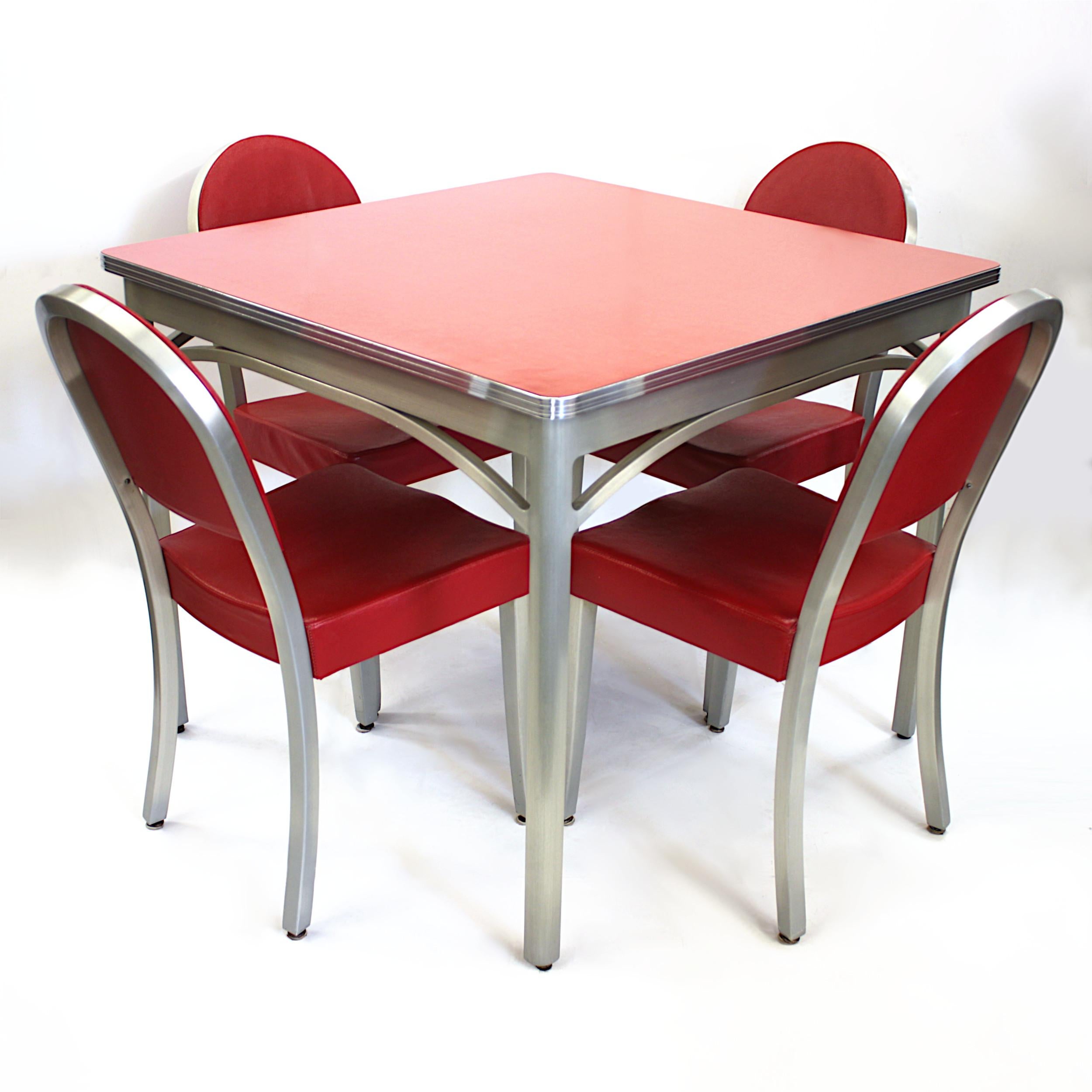 Vintage 1940s cafe table and chairs set by GoodForm Furniture Co., a division of The Gernal Fireproofing Co. 

Set features:

- Welded, brushed-aluminum frames
- Red Formica table-top
- Red vinyl upholstery
- 4 chairs

Dimensions:

Table: