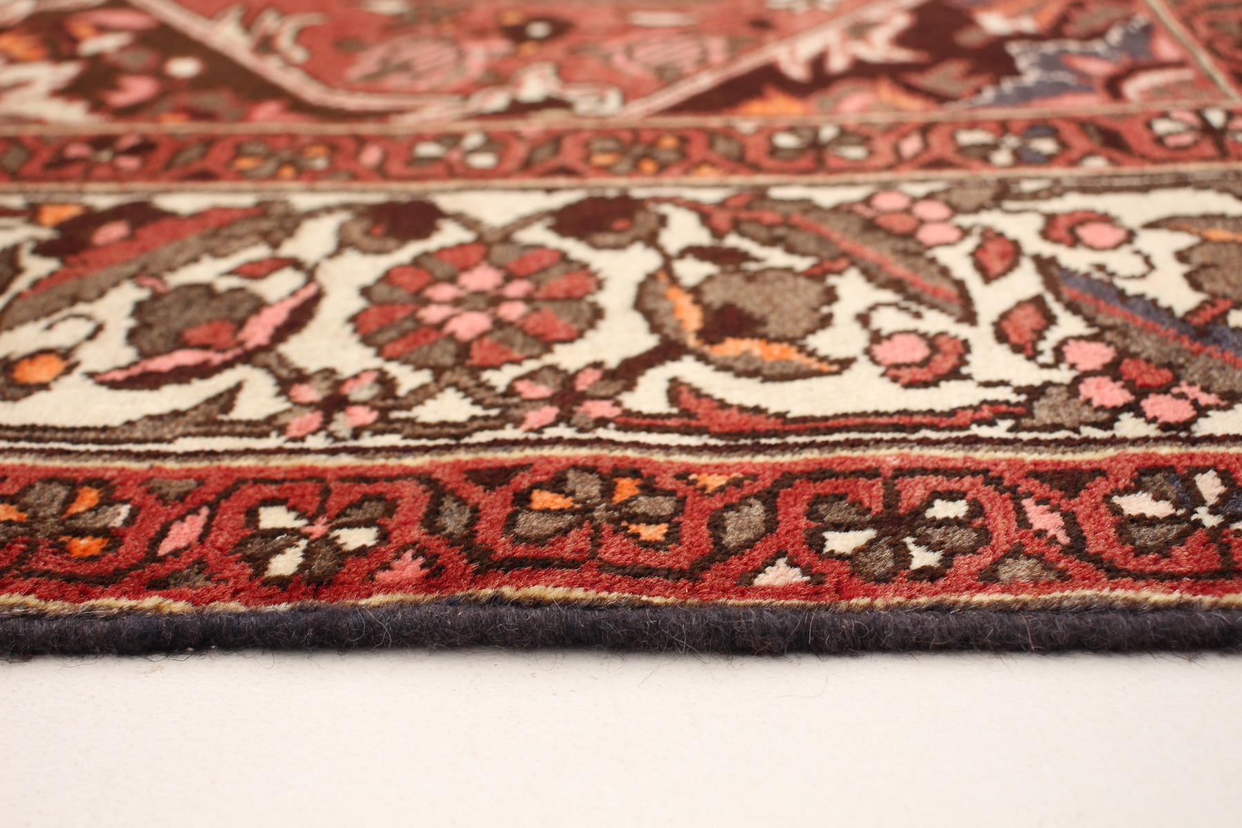 Building a warm and inviting garden-themed design, this Persian Bakhtiari carpet measures 7'x9'8