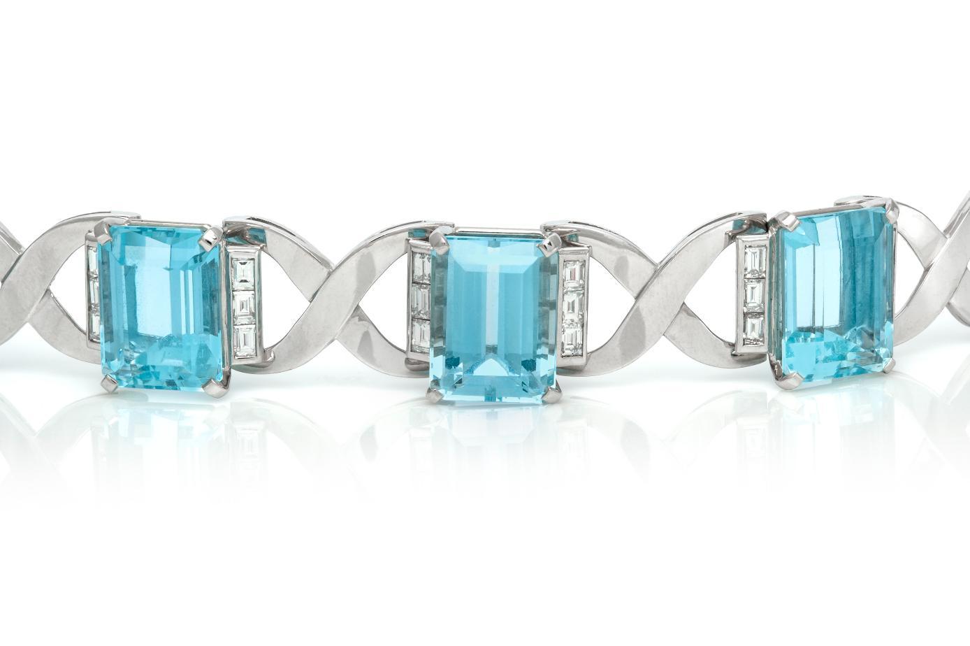 Finely crafted in 18k white gold featuring six Emerald cut Aquamarines weighing a total of approximately 90.00 carats and Baguette cut Diamonds weighing a total of approximately 3.60 carats, F-G color, VS1-VS2 clarity. 
Circa 1940s
Size 8 1/2