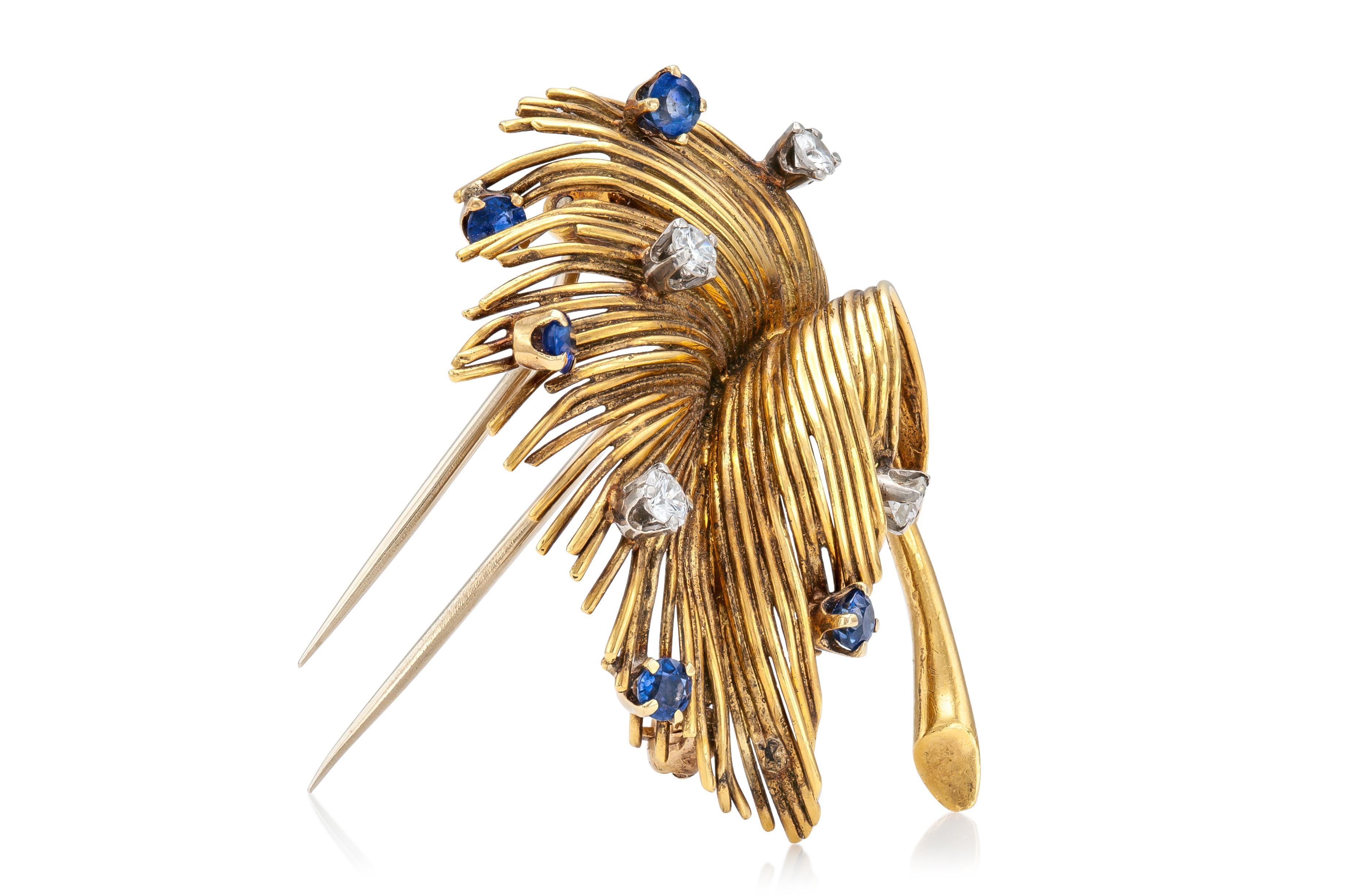 Finely crafted in 18k yellow gold with Round Brilliant cut Diamonds weighing a total of approximately 0.50 carat and Round cut Sapphires weighing a total of approximately 0.70 carat.
Signed by Tiffany & Co.
Circa 1940s
1 1/2 inches diameter