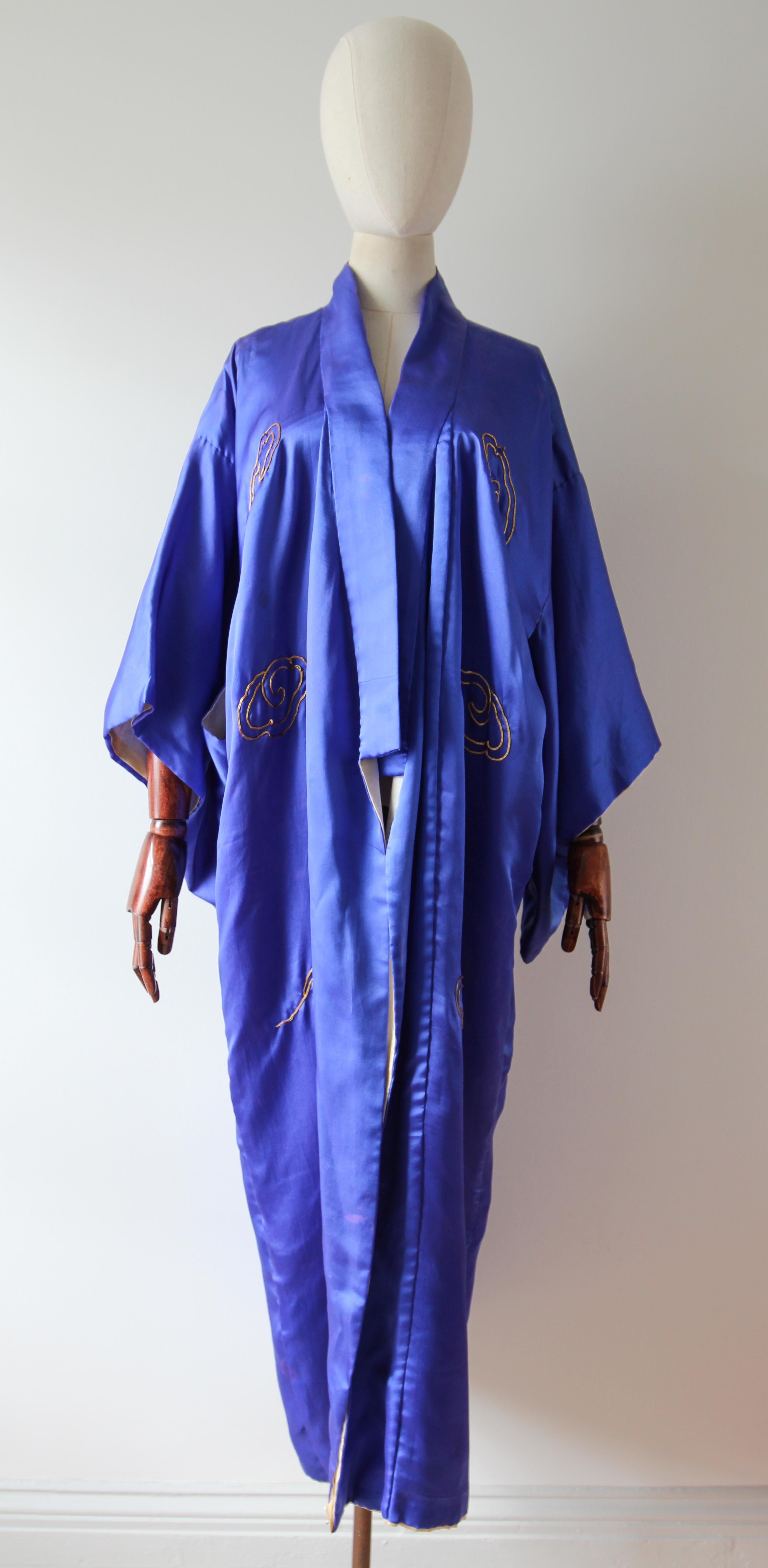 This truly magnificent vintage 1940's silk satin embroidered kimono, in a vibrant shade of Royal blue, is the perfect piece for your loungewear collection.

The classic kimono cut is framed by a V shaped neckline and an edge to edge cut. The