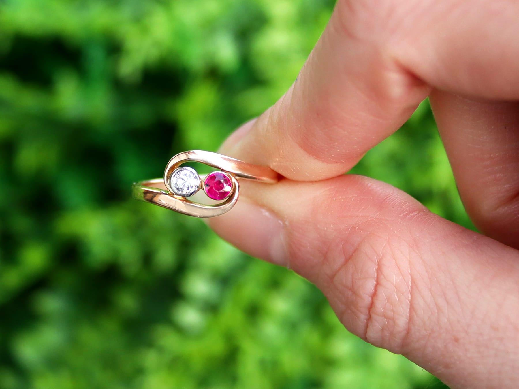 An impressive vintage 0.09 carat diamond and 0.15 carat ruby, 14 karat yellow gold and 14 karat white gold set twist ring; part of our diverse antique jewelry and estate jewelry collections.

This fine and impressive ruby ring has been crafted in