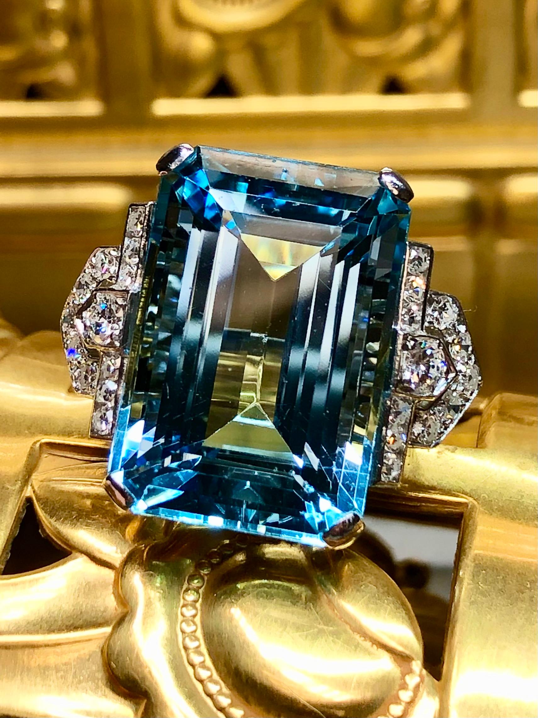 An absolutely stunning cocktail ring c. the early 1940’s hand done in platinum and centered by a 31.55ct natural Santa Maria aquamarine exhibiting the deep blue color that is so highly coveted by aquamarine buyers all over. The center stone is