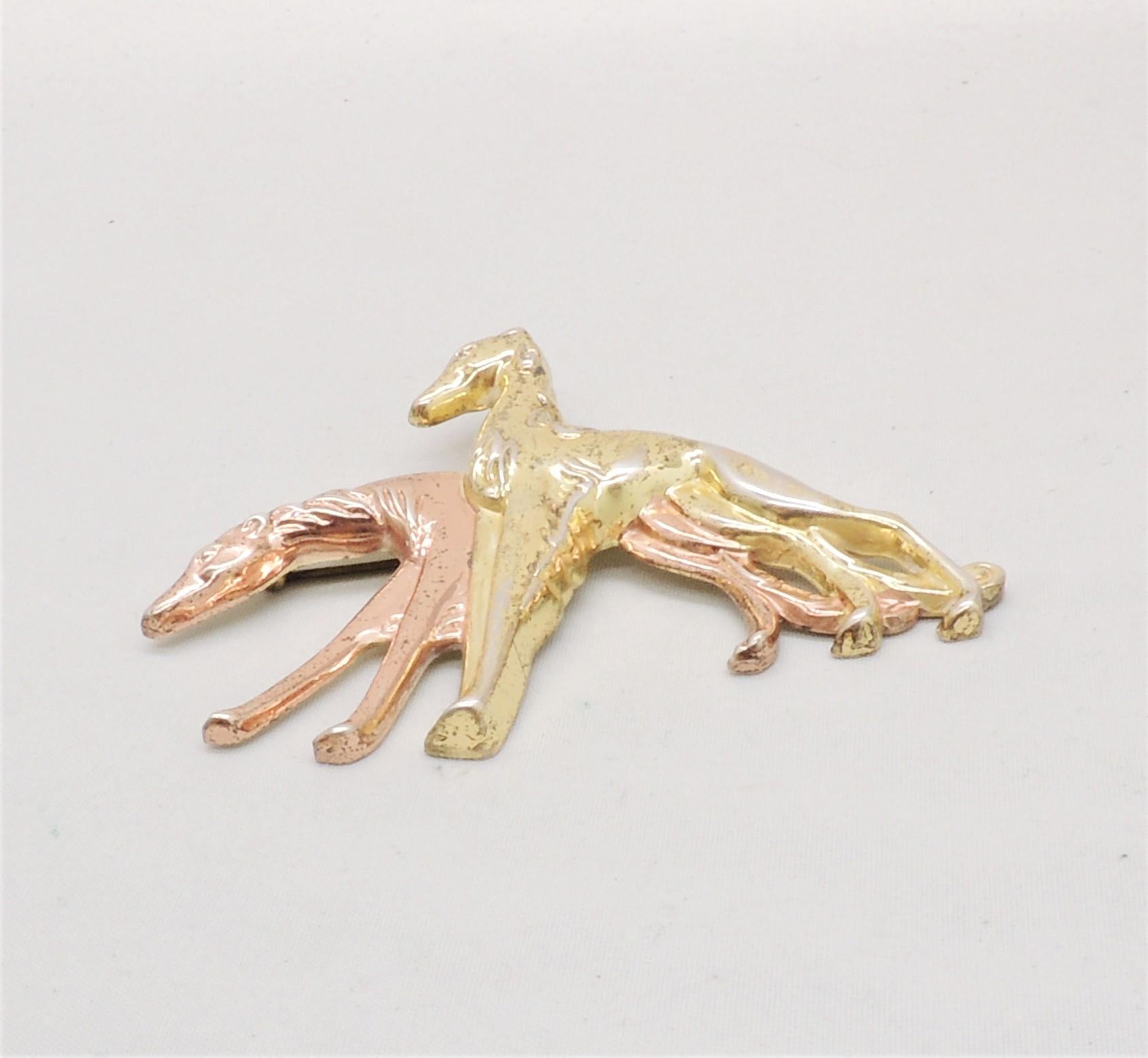 Rare 1940s sterling goldtone and pink gold plated two greyhounds brooch with security clasp. Marked 