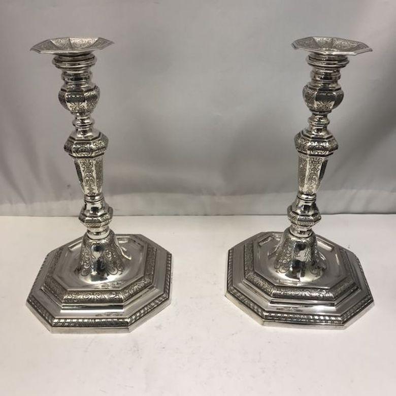 A pair of silver candlesticks made in 1940 sitting on octagonal bases. Both are beautifully decorated and hallmarked.