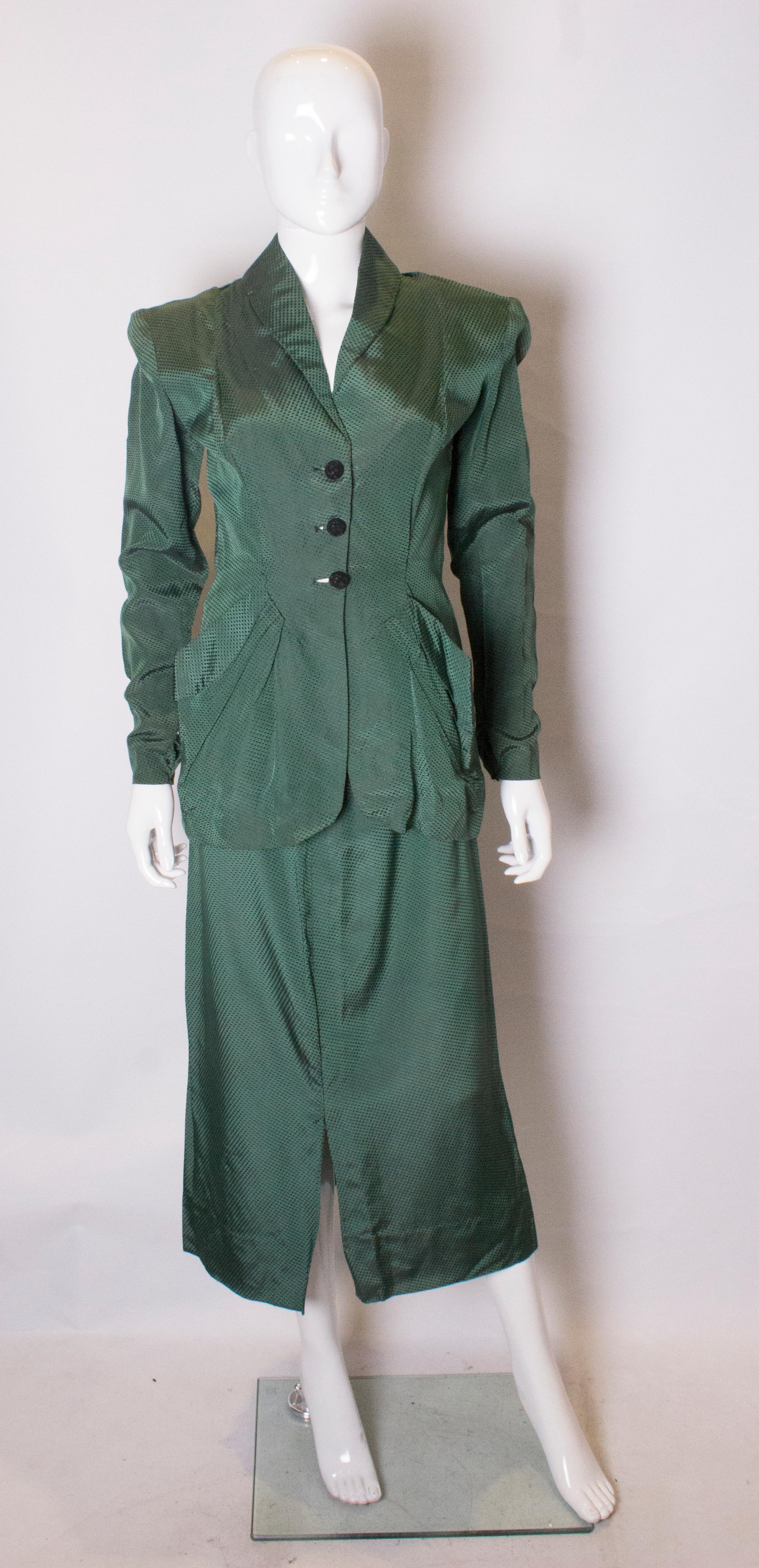 A chic vintage skirt suit  dating from the 1940s. The jacket has a three button front fastening, two pockets at the front,  and weights in the hem so it hangs well. 
The skirt  has a back central zip, and an 8 1/2 slit at the back and 11 '' slit at
