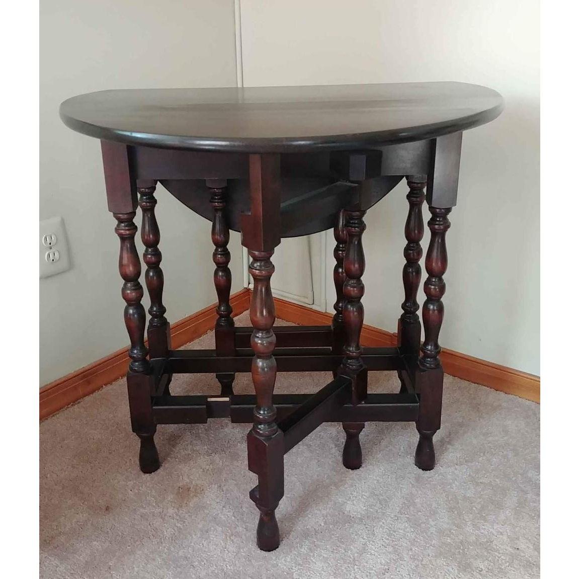 An antique Solid Mahogany wood gateleg accent table. Features the oval planked drop-leaf top. Table top sits on turned legs joined by stretchers. The original 17th century English.
Table measures with leaves dropped: 13 W x 30 D x 30 H
And with
